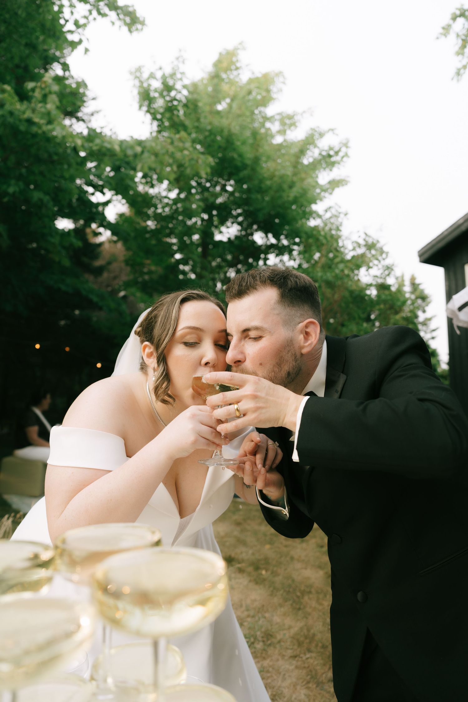 Festive champagne tower pouring at an outdoor celebration.
