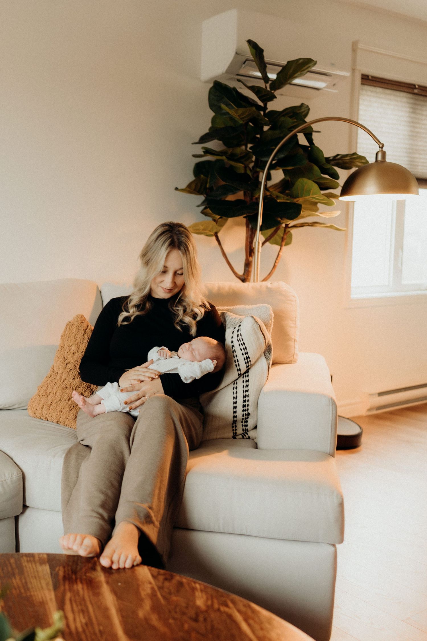 Relaxing scene on a light grey couch with indoor plants and warm ambient lighting.