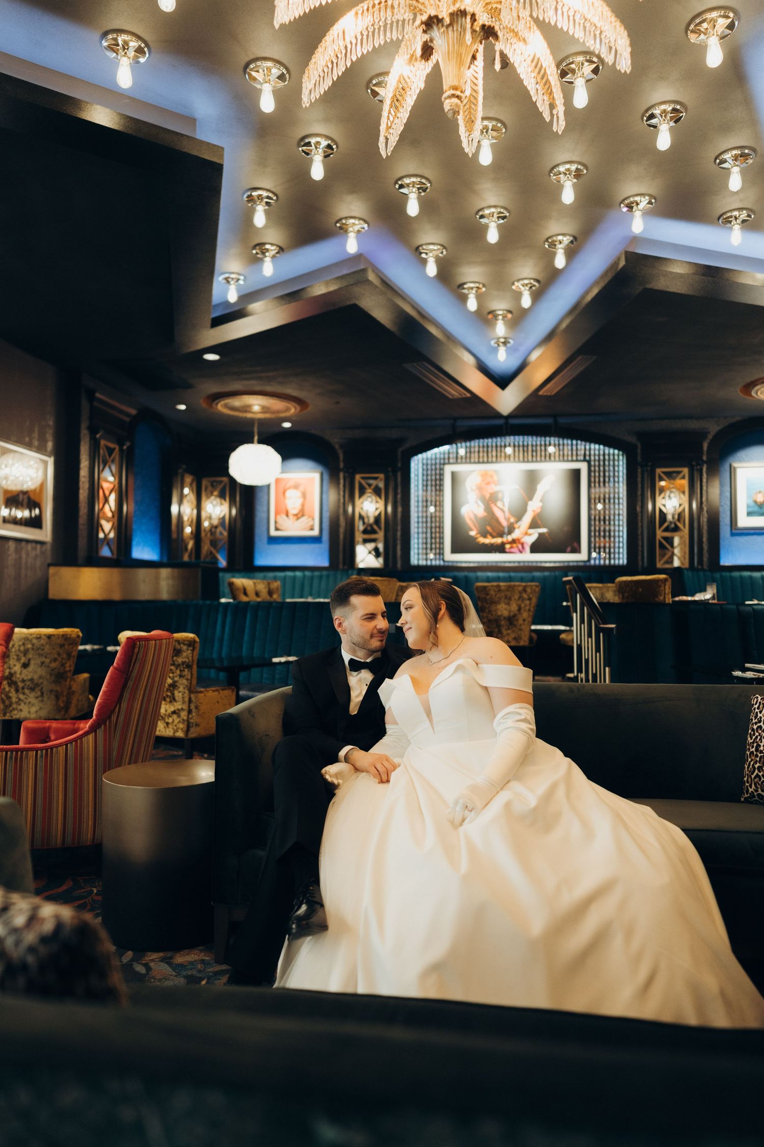 Romantic scene in an upscale lounge with ornate ceiling fixtures and plush seating areas.