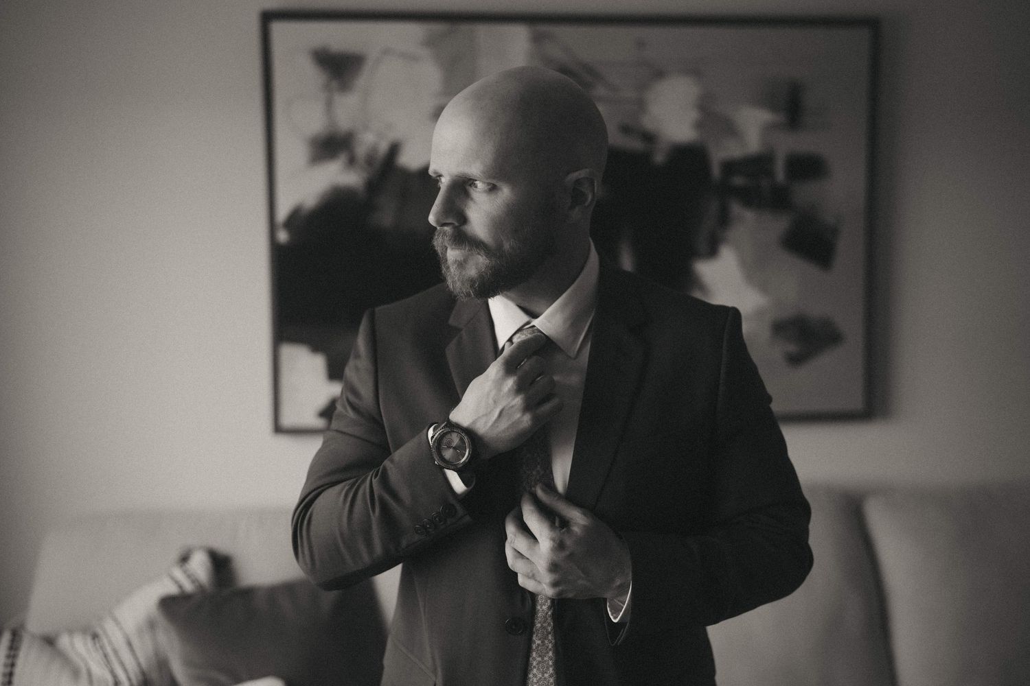 Elegant black and white portrait series of groom preparation moments.