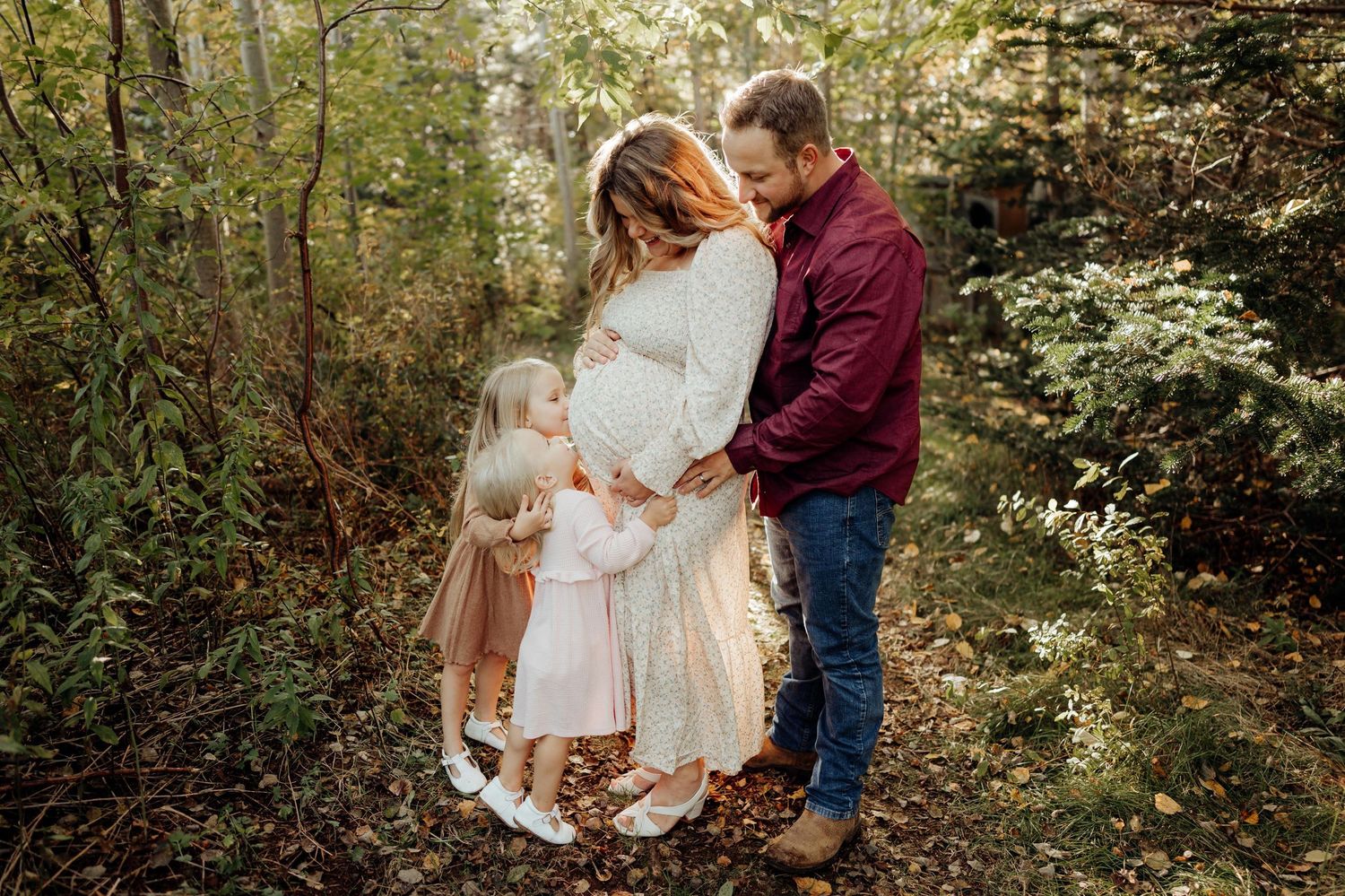 Natural outdoor family portraits captured among fall foliage and trees.