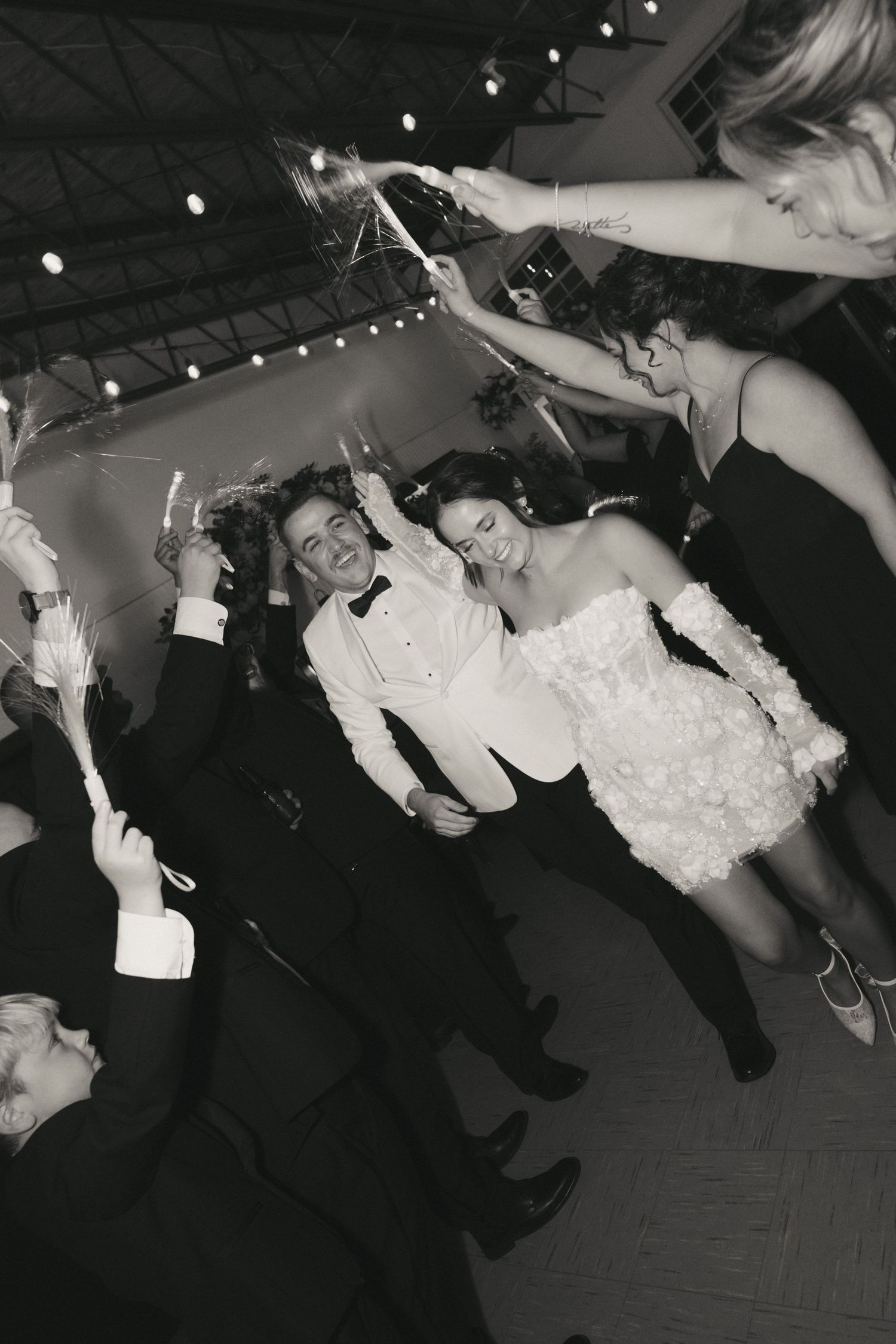 A sequence of black and white photos showing a couple dancing and dipping at a wedding reception.