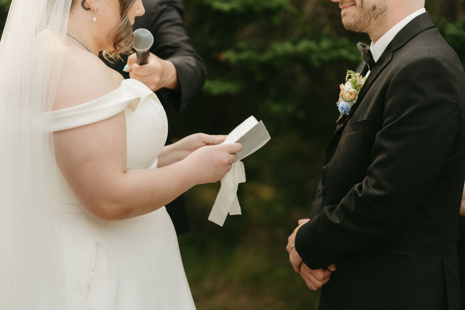 Intimate wedding ceremony moment with couple exchanging vows outdoors.