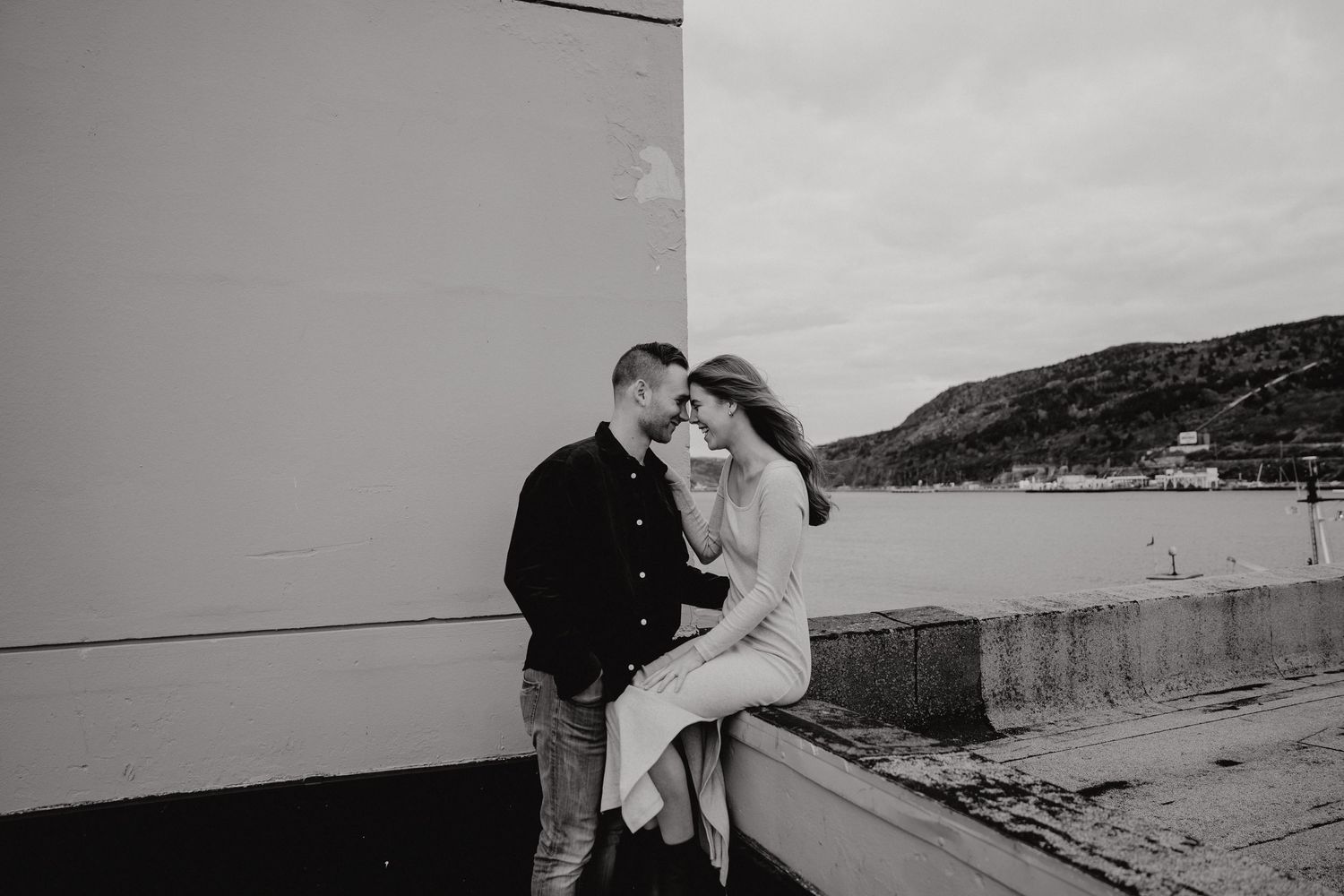 A romantic black and white photo session captured in a coastal setting.