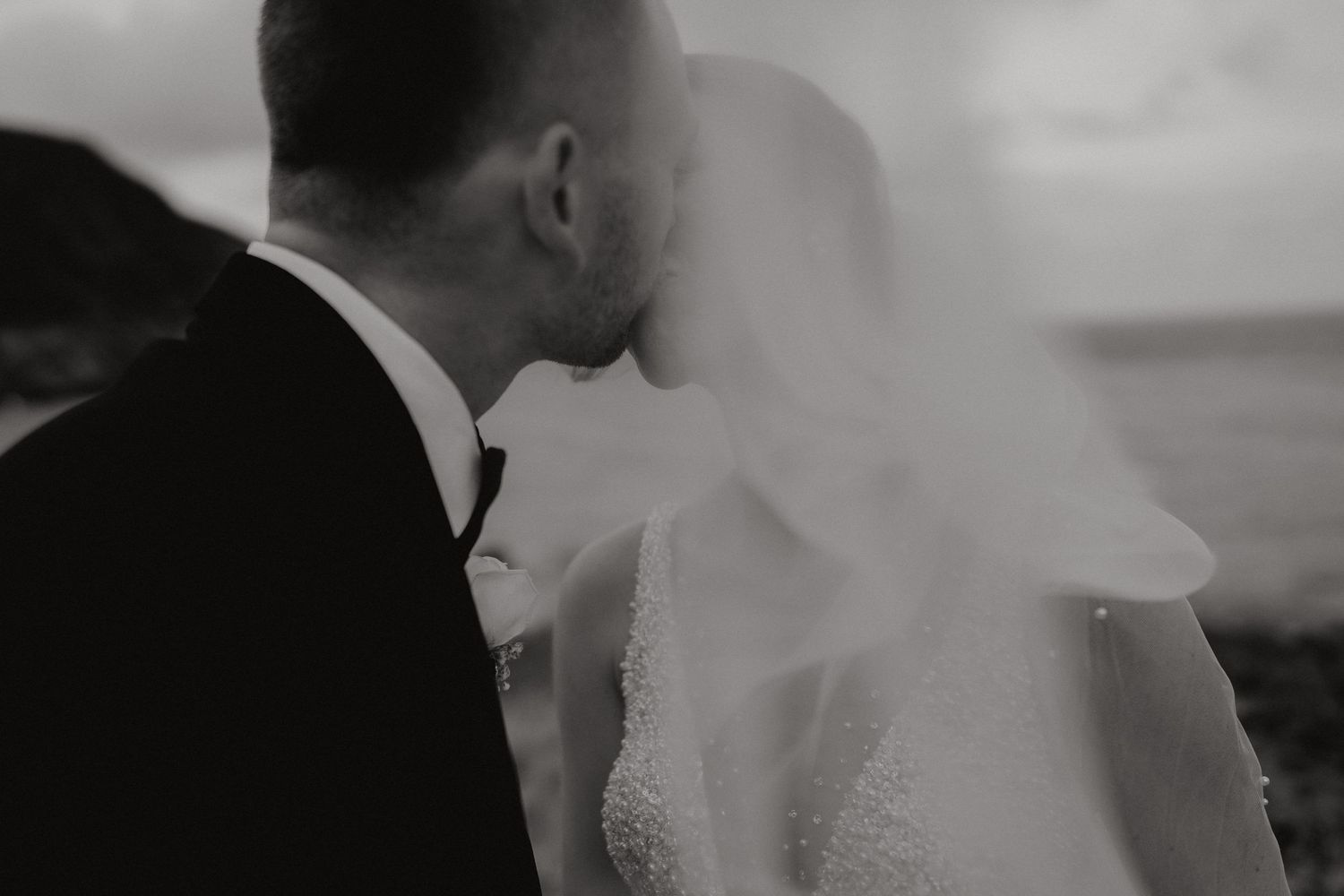 Romantic black and white silhouette of a couple embracing on their wedding day.