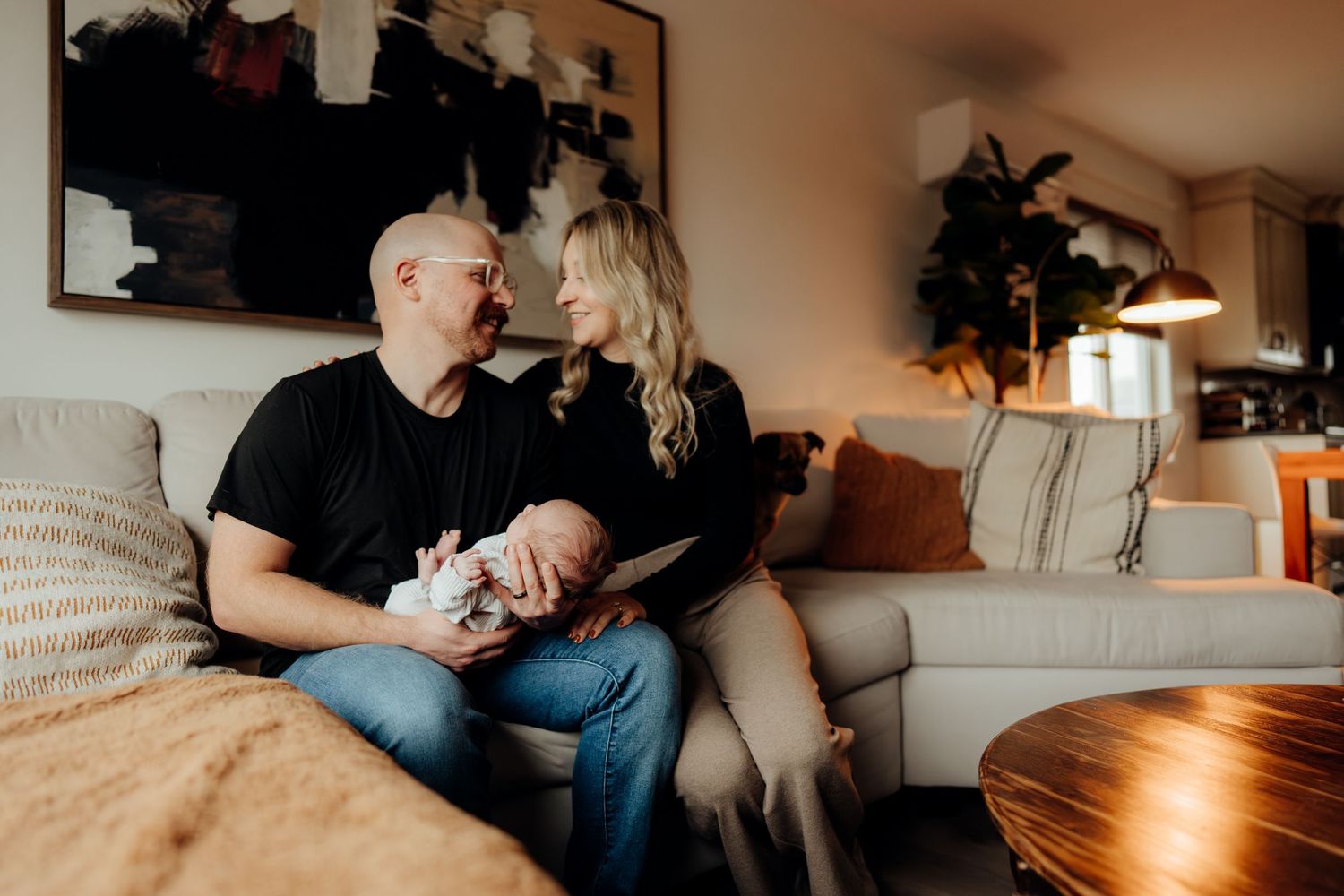 Warm living room scene with family members sharing tender moments on a light colored couch.