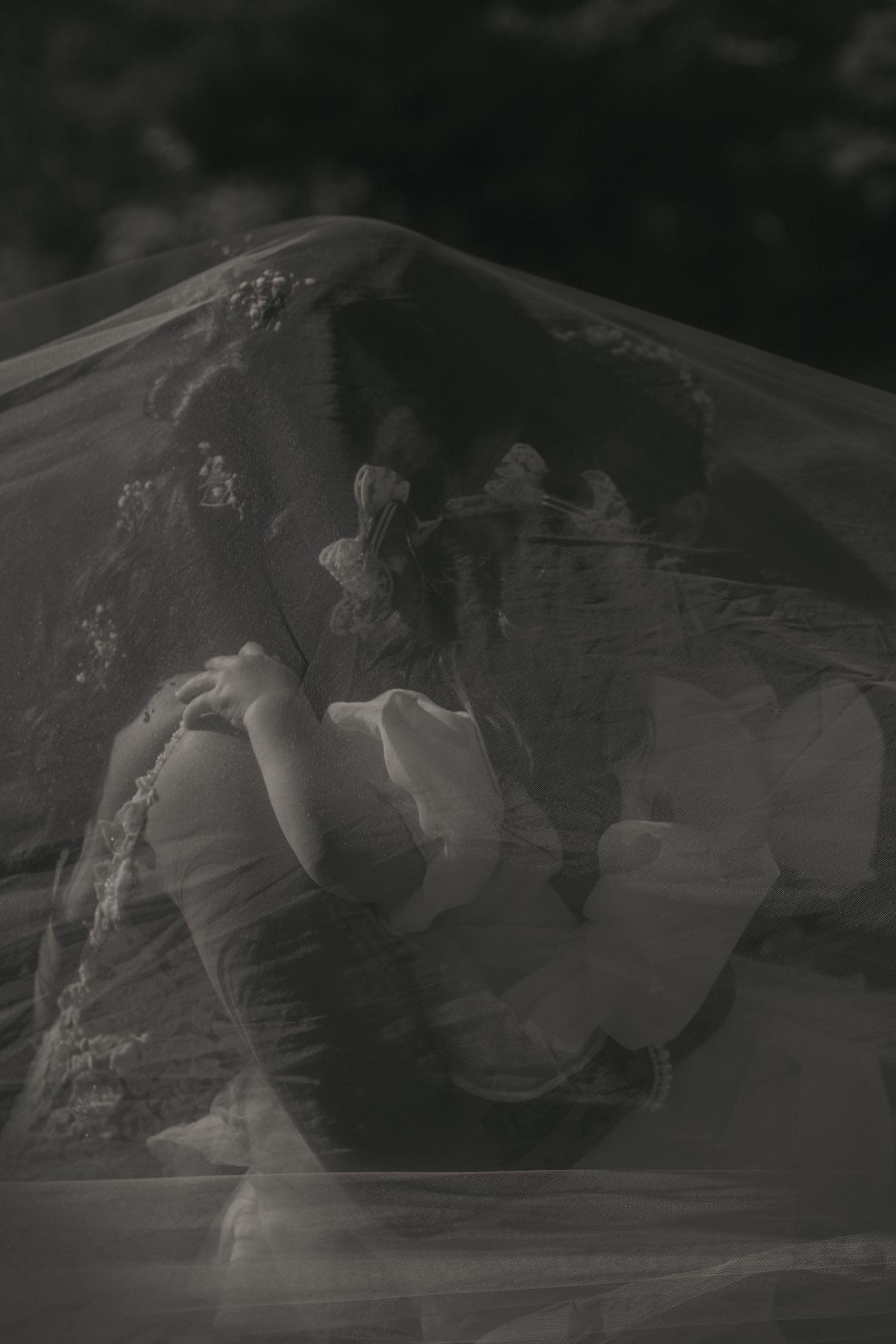 A blurred black and white sequence of motion showing figures in a dynamic performance or dance routine.
