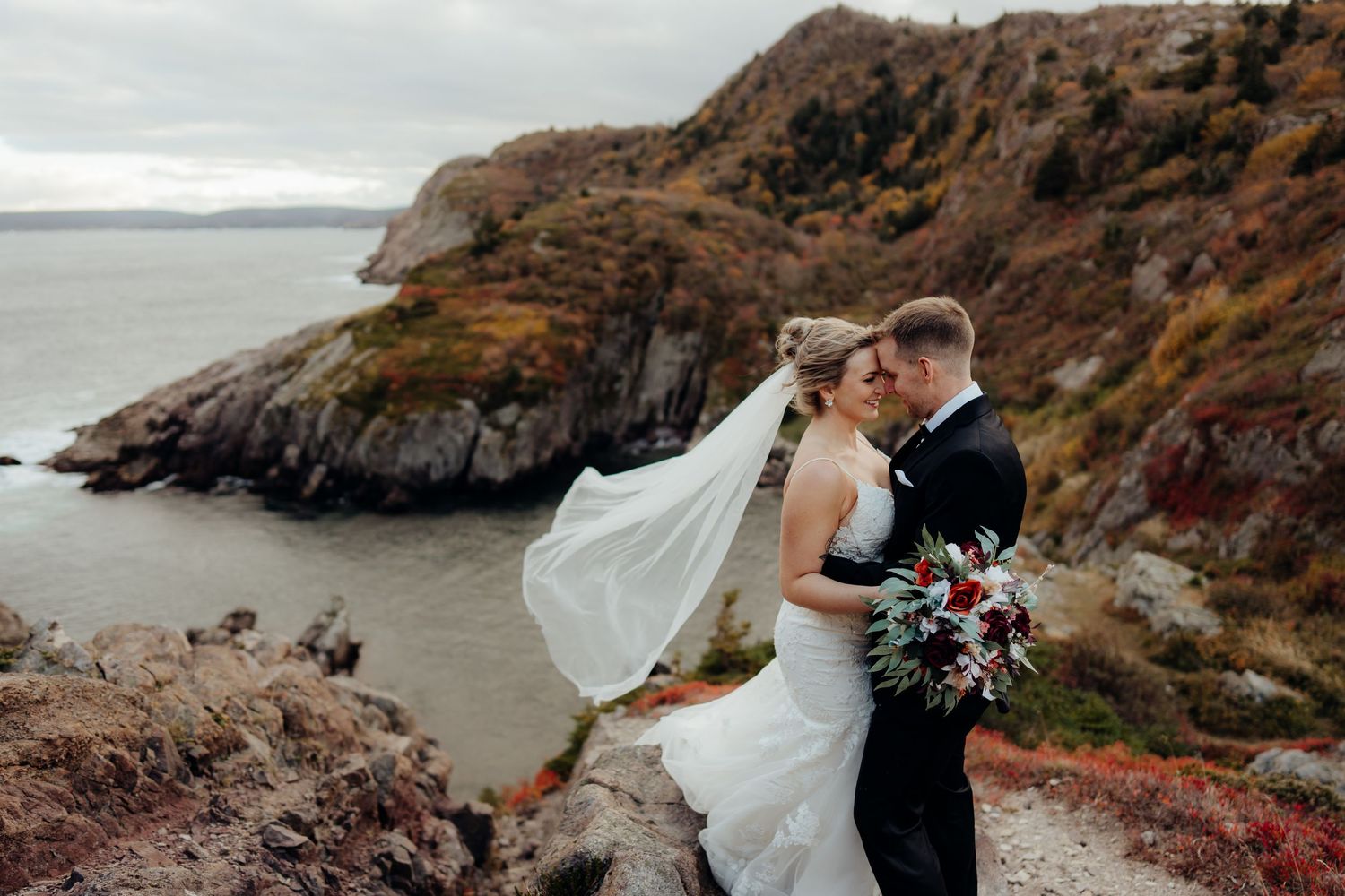 Stunning coastal wedding portraits with dramatic cliffs and ocean views.