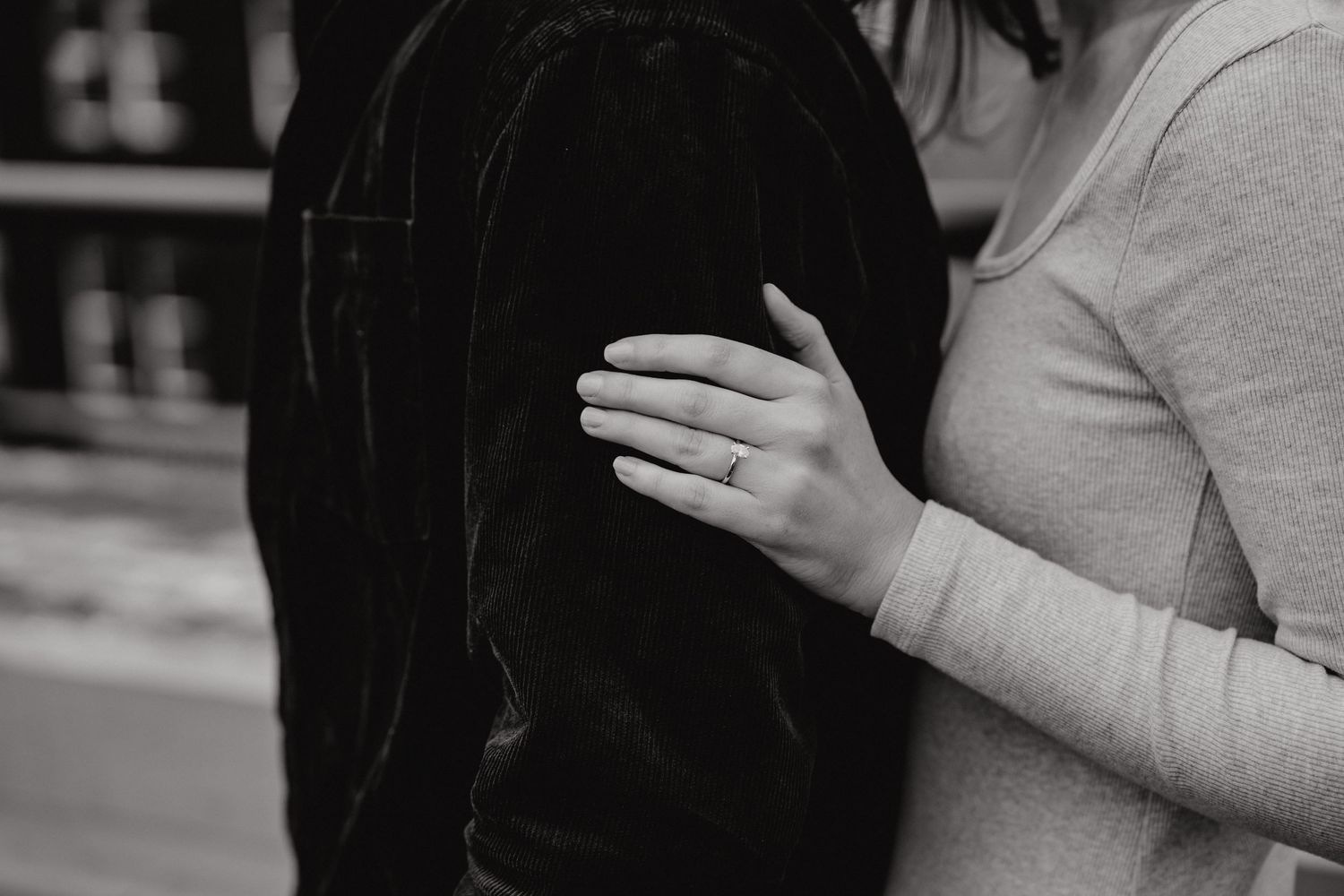 Couple sharing an intimate moment together in an urban setting at dusk.