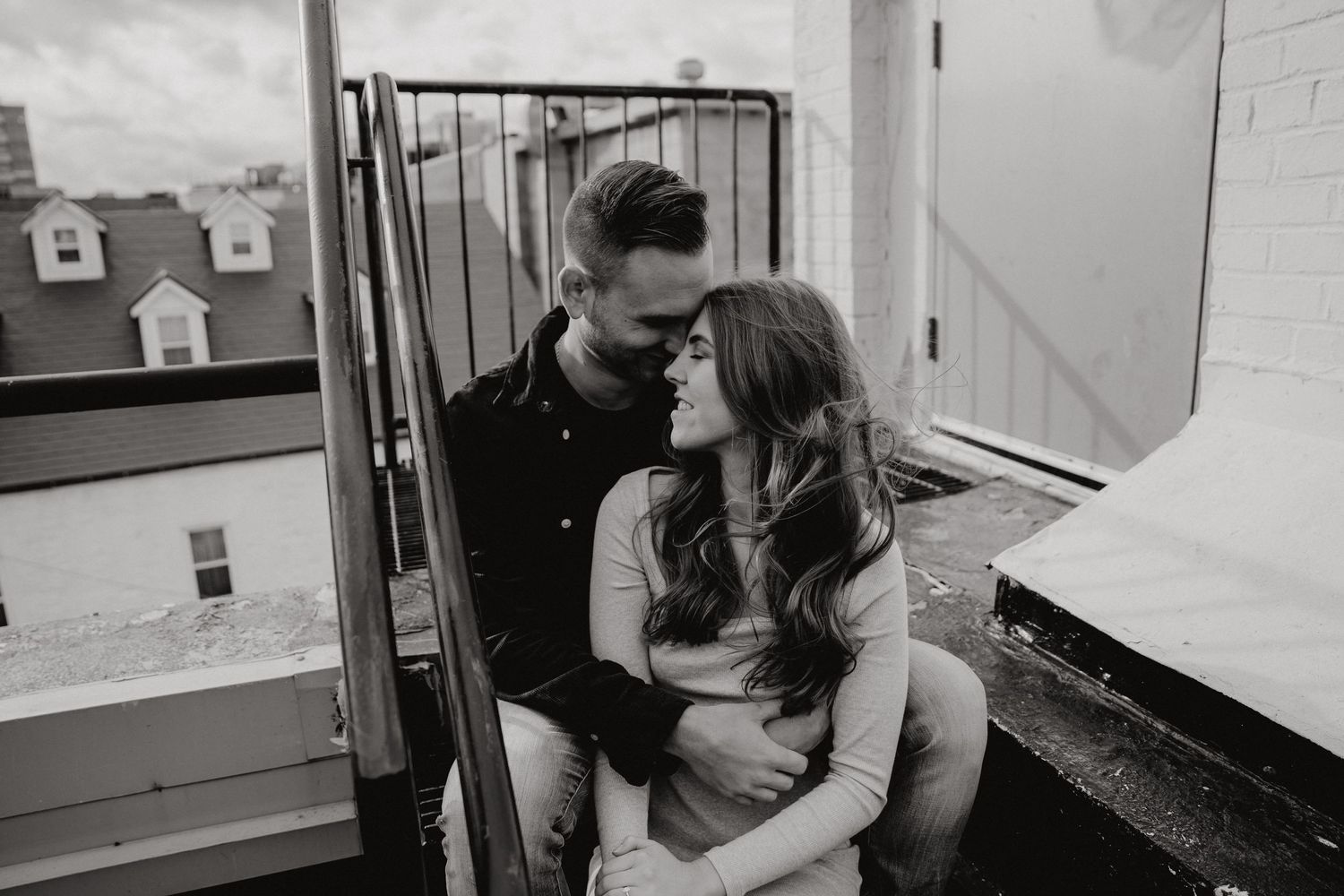 Series of intimate couple photos captured against industrial rooftop backdrop.
