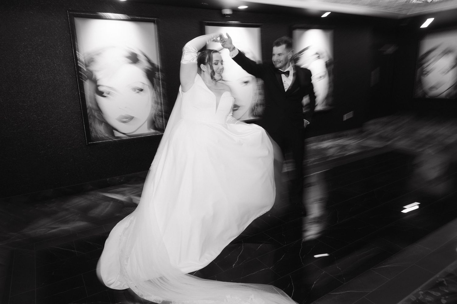Artistic black and white motion blur captures romantic wedding moments in low light.