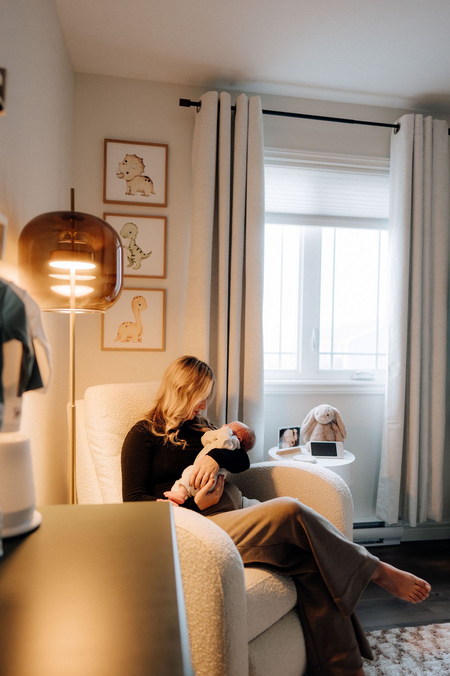 Black and white interior photo showing a bright room with curtains and modern furnishings.