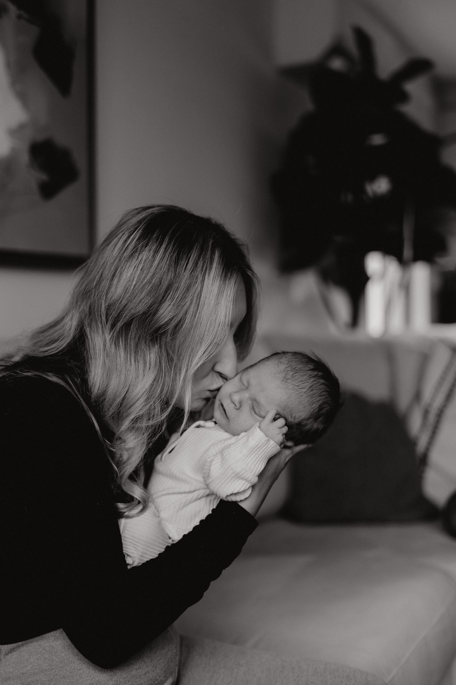 Intimate black and white photography sequence showing tender emotional moments between family members.
