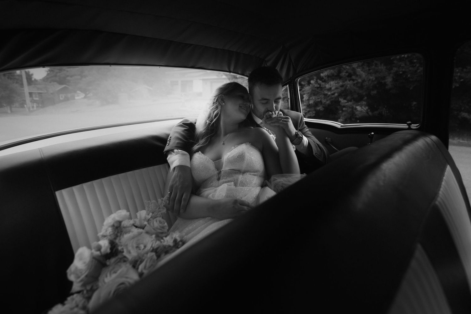 A series of black and white surveillance camera footage showing movement inside a vehicle at night.