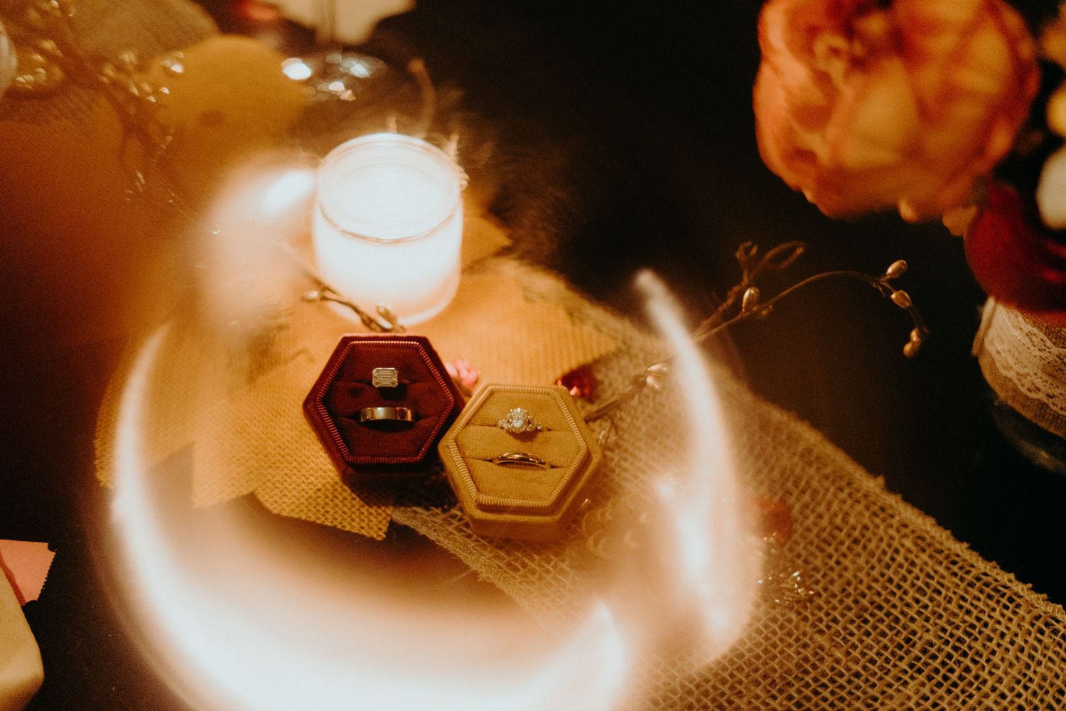 Warm candlelit details with rustic decor elements on burlap tablecloth.