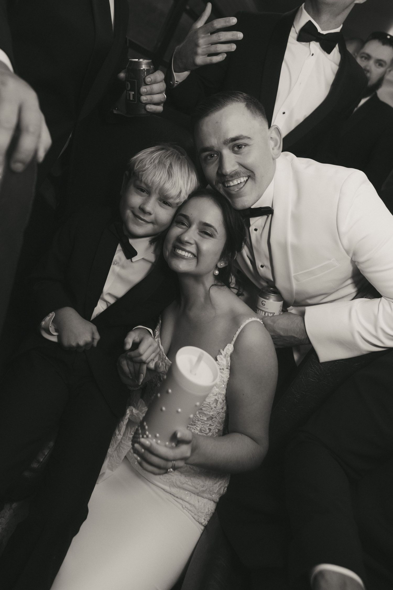 A sequence of black and white photos showing a couple dancing and embracing at a formal event.