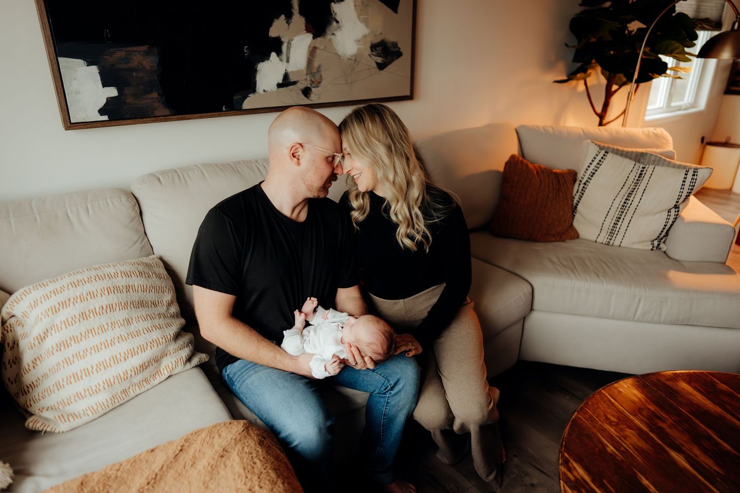 Natural documentary-style photograph of family bonding in a contemporary living room setting.