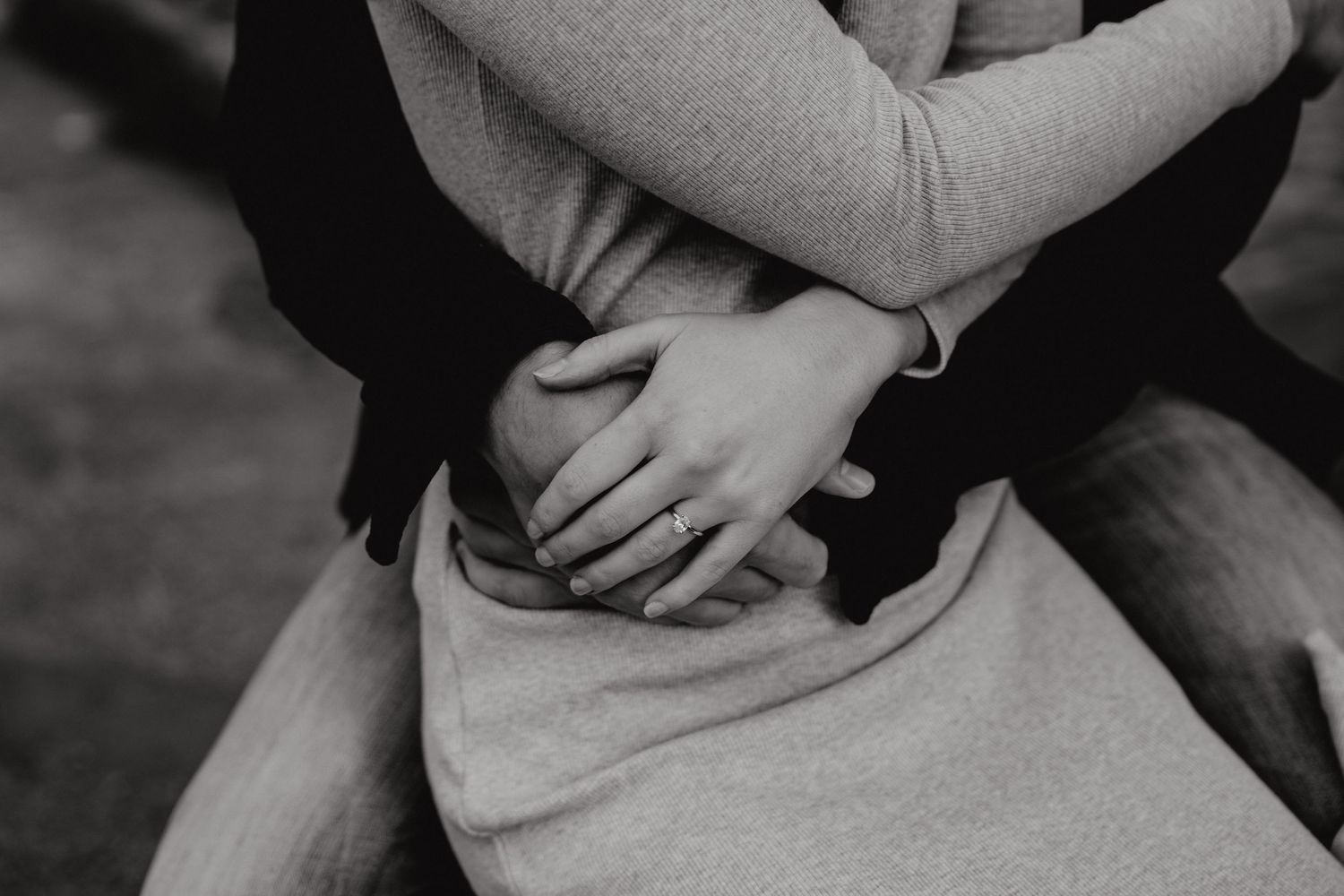 Close-up shot of hands clasped together showing intimate moment.