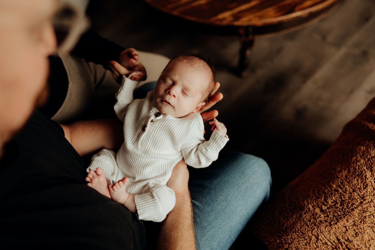 Documentary style photos showing tender family interactions with newborn.