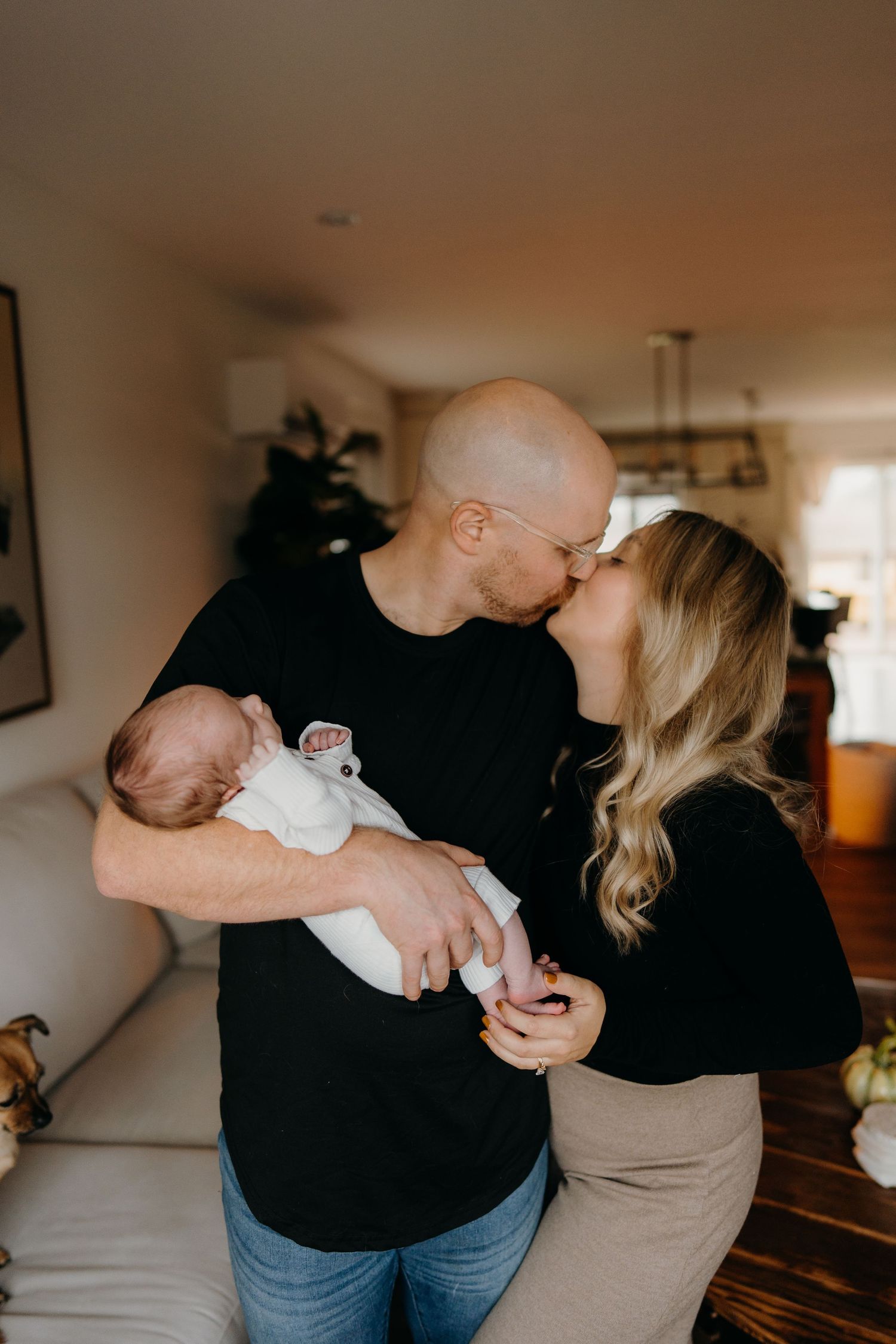 Intimate lifestyle photography session showing tender family moments in a cozy home setting.