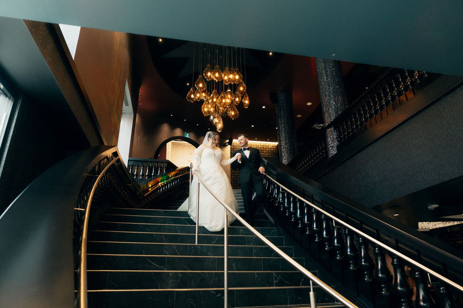 Dramatic architectural photography of a modern staircase with moody lighting and geometric shadows.