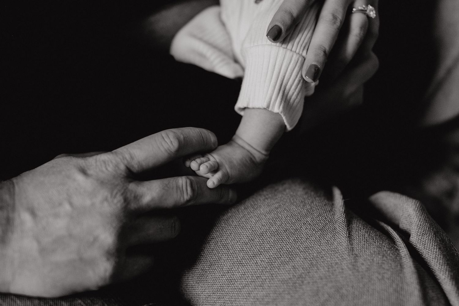 Close-up details of hands and textures during an intimate photo session.