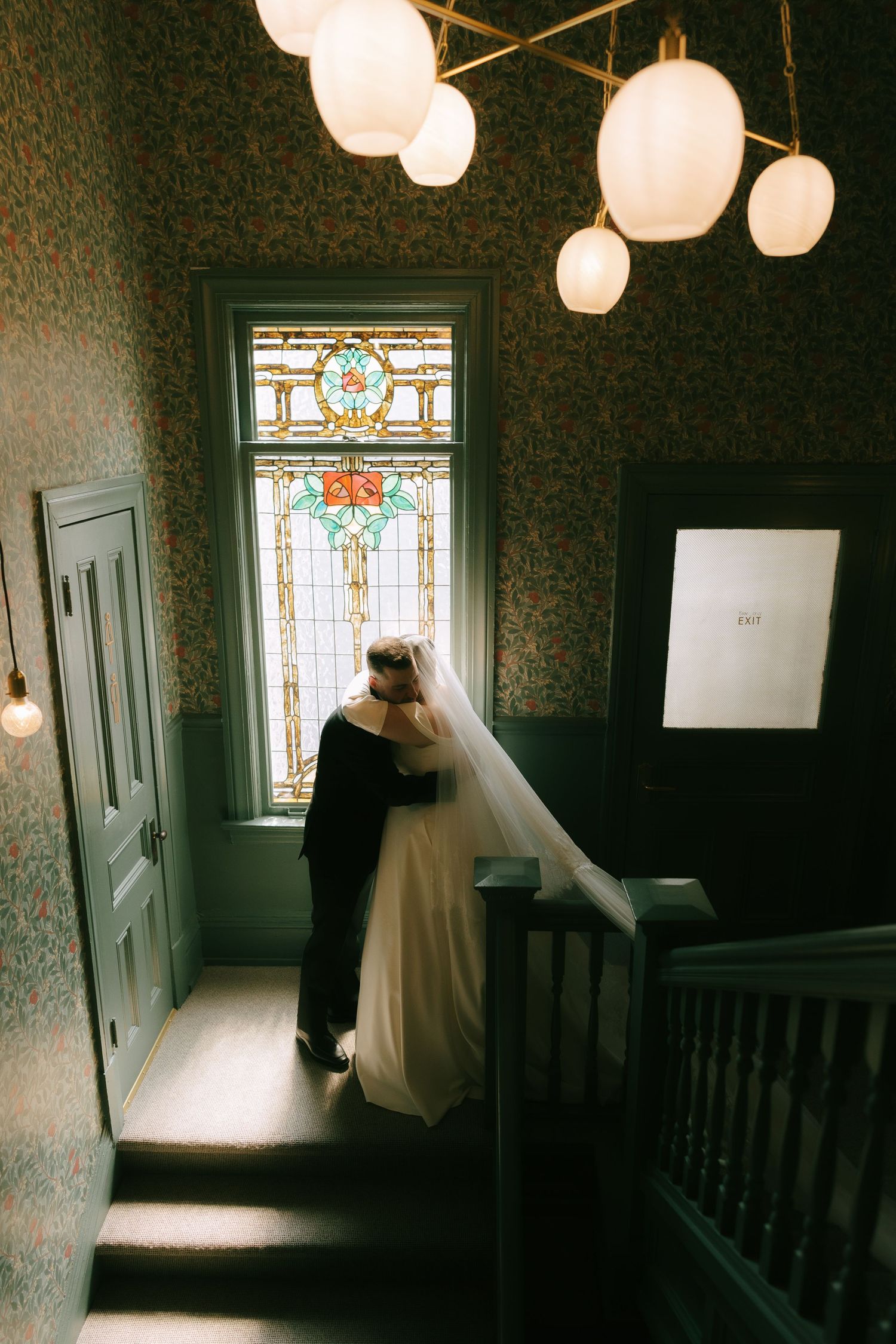 Wedding scene with paper lanterns and stained glass window.