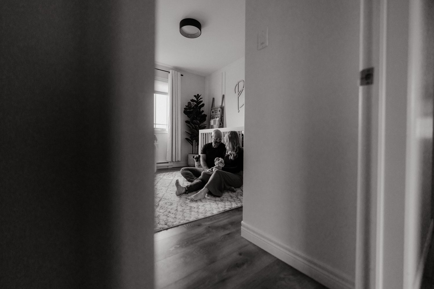 Monochromatic hallway view with dramatic lighting and shadows.
