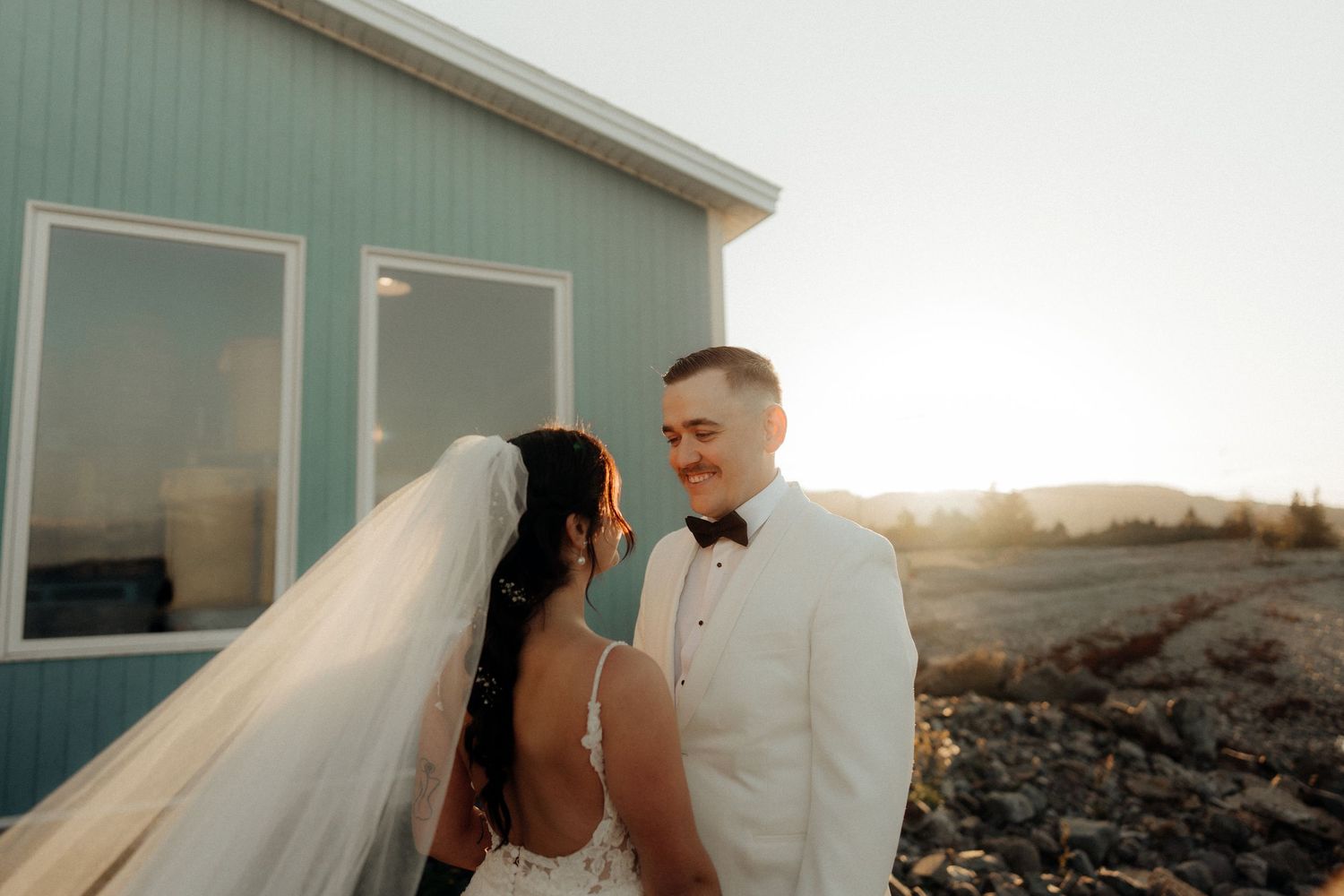 A couple shares a romantic moment on a beach at sunset with multiple candid shots showing their embrace.