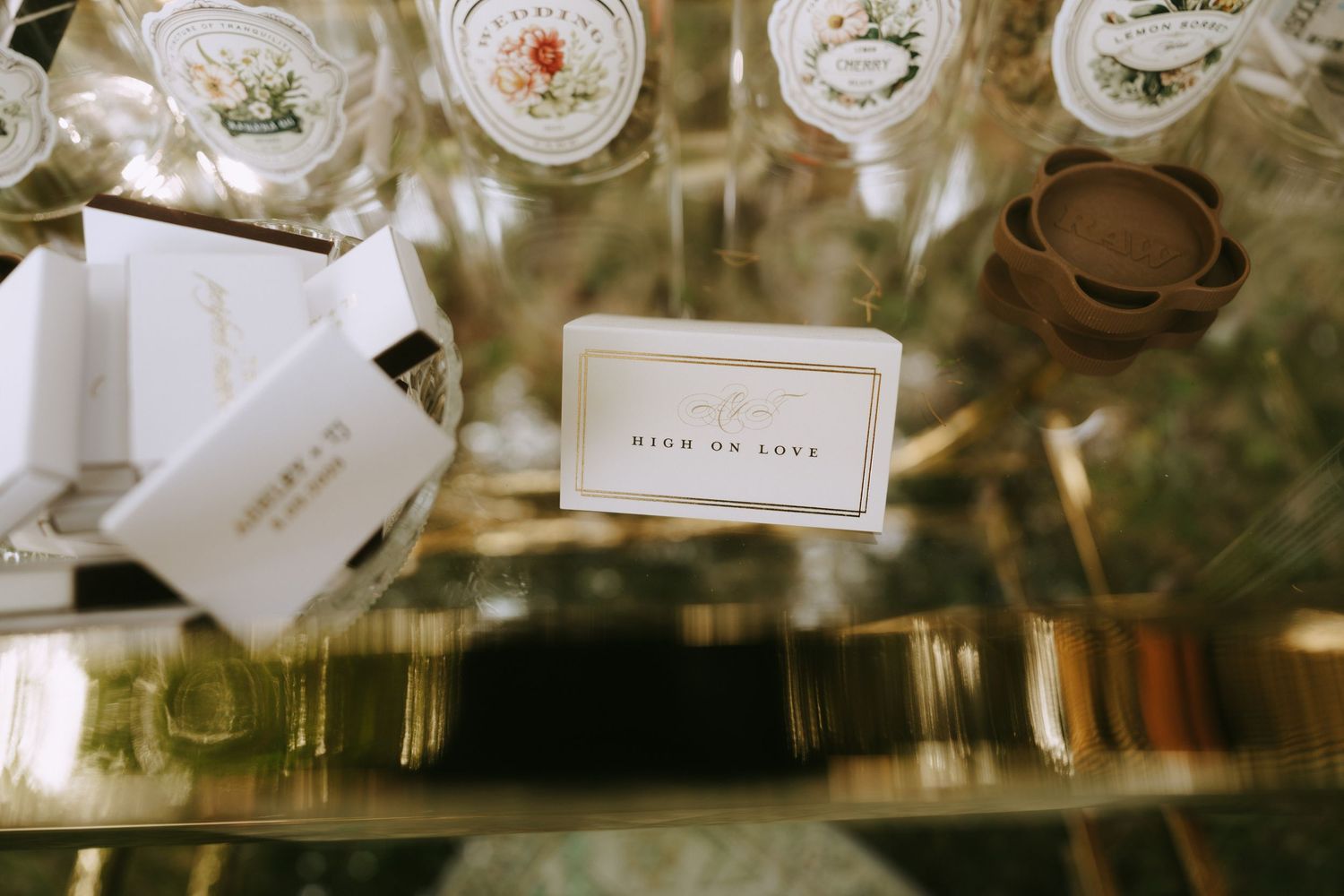 Vintage teacups and saucers displayed on gold shelving with decorative labels.