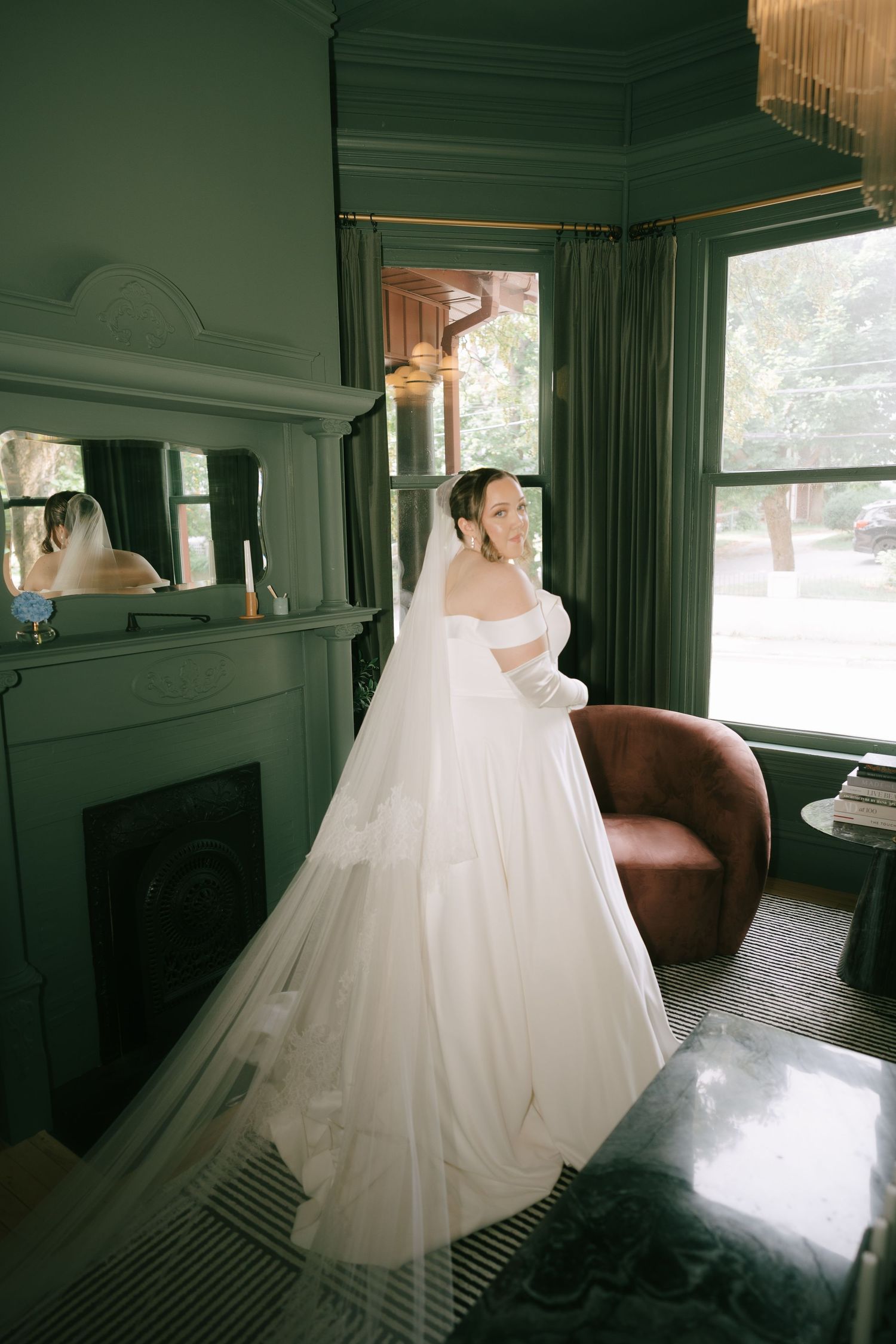 A billowing white wedding gown photographed in a vintage room with natural light.