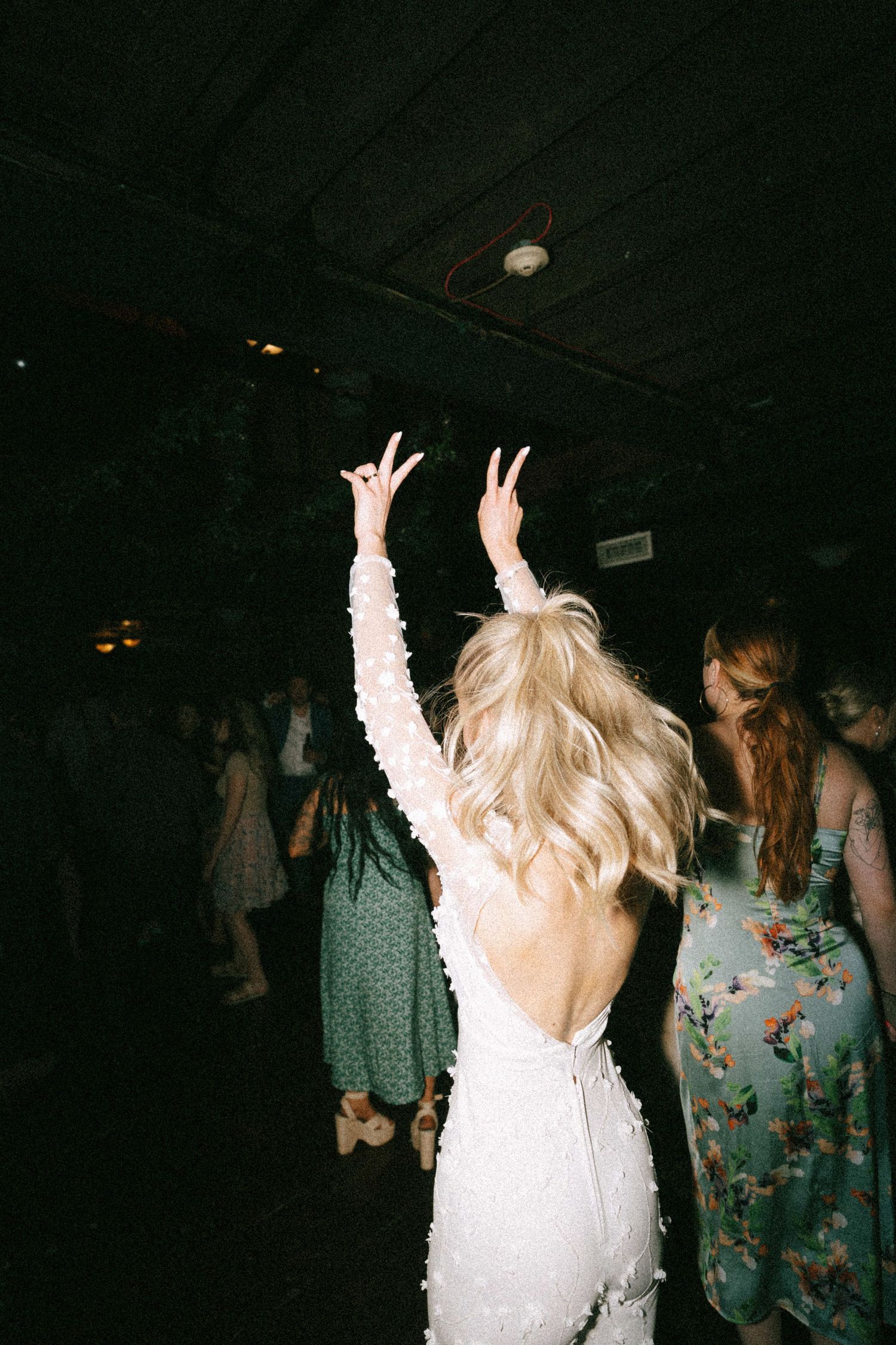 Dance floor celebration with people in formal attire.