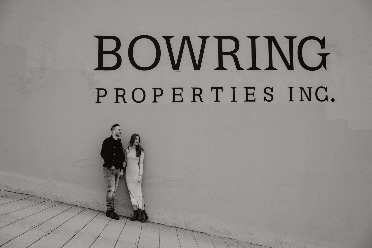 Black and white signage displaying 'BOWRING PROPERTIES INC.' on a wall.