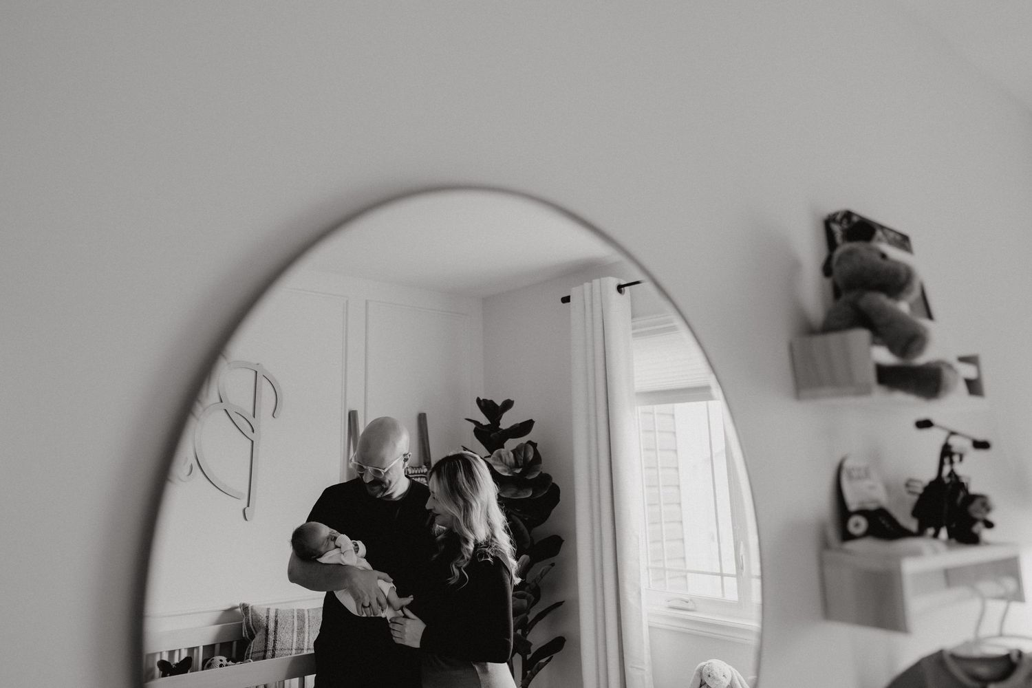 A series of reflections in a round mirror showing a nursery room interior.