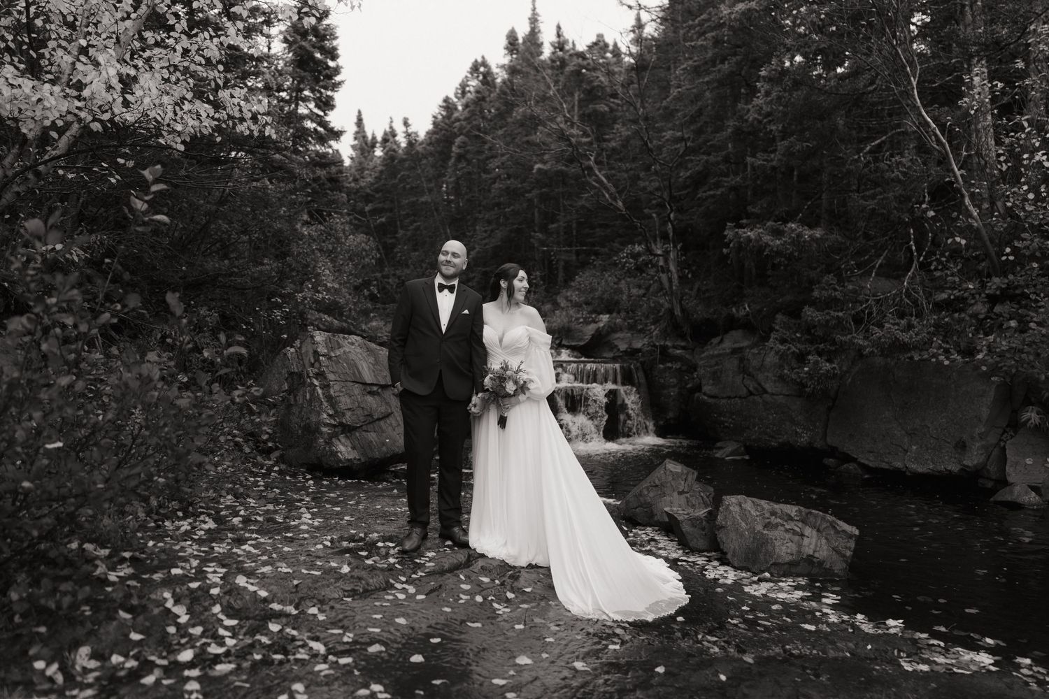 Black and white photo series showing a couple walking through a scenic forest path during what appears to be a wedding day.