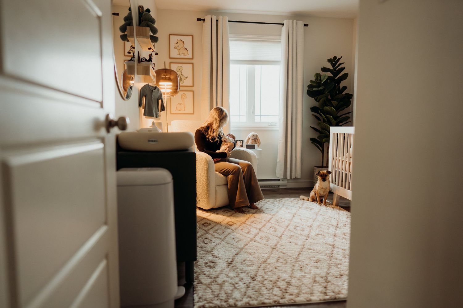 Wide angle view of modern nursery with white crib and window.