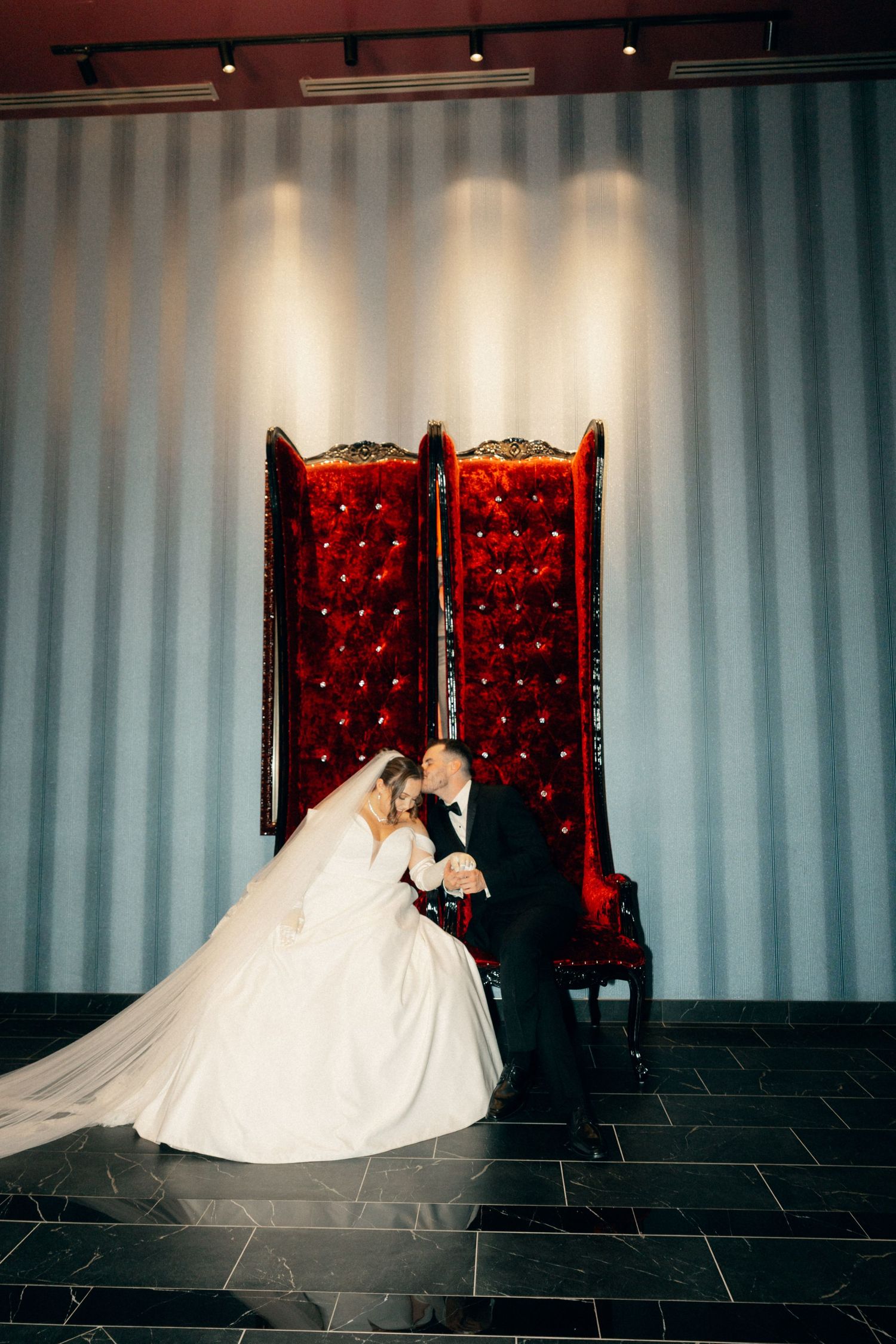 Elegant bridal portrait sequence featuring a flowing white gown against red velvet chairs.
