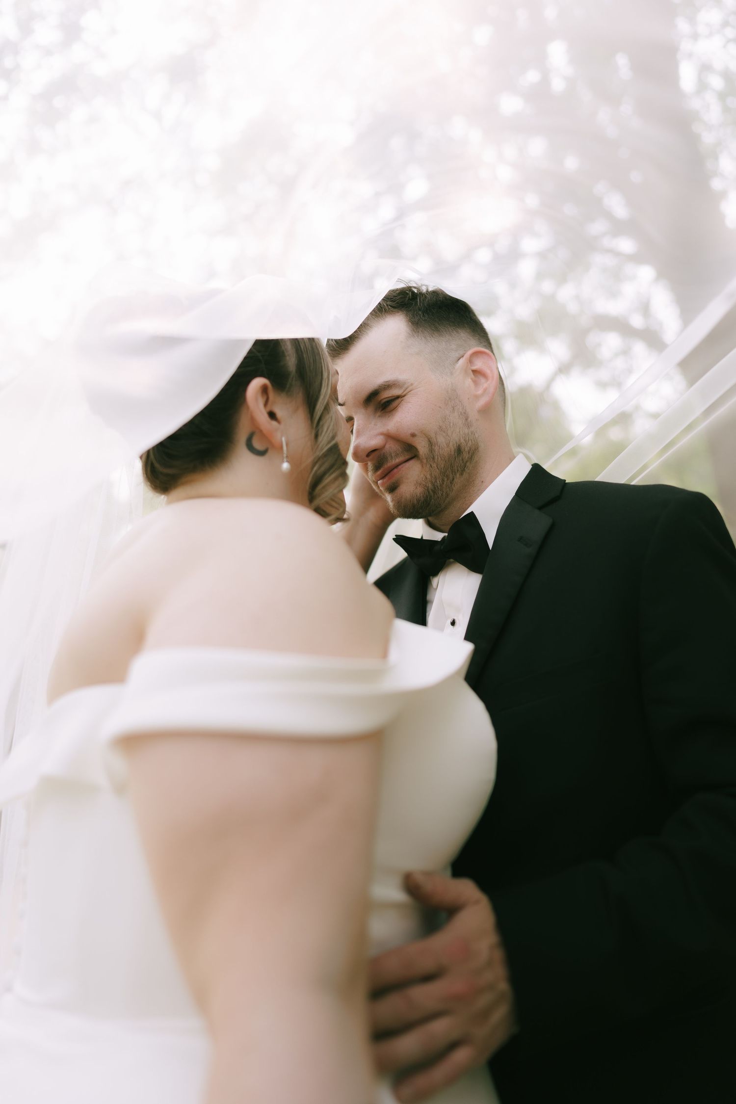Romantic outdoor wedding portraits with soft natural lighting and emotional expressions.