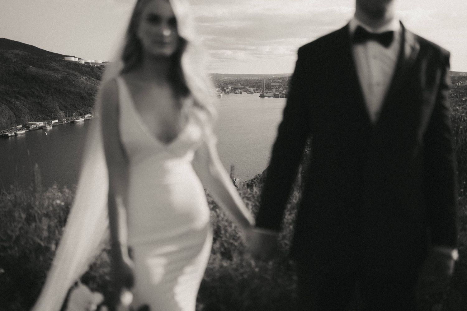 Black and white candid wedding moments captured against a coastal landscape.