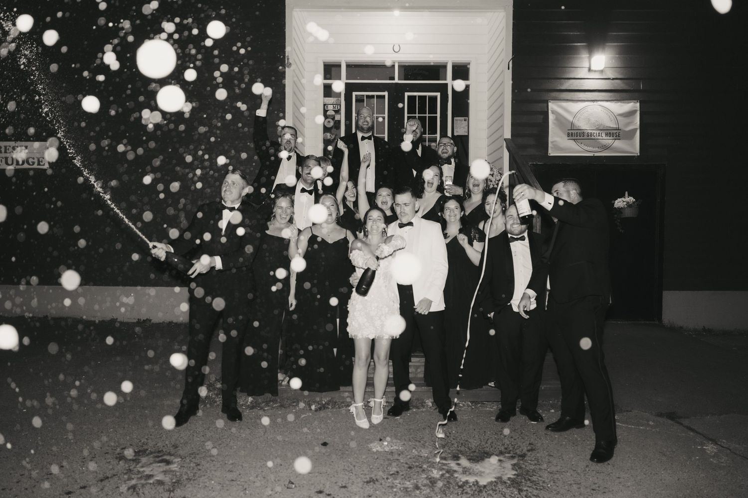 Black and white photos show people celebrating at a nighttime event with glowing bubbles floating through the air.