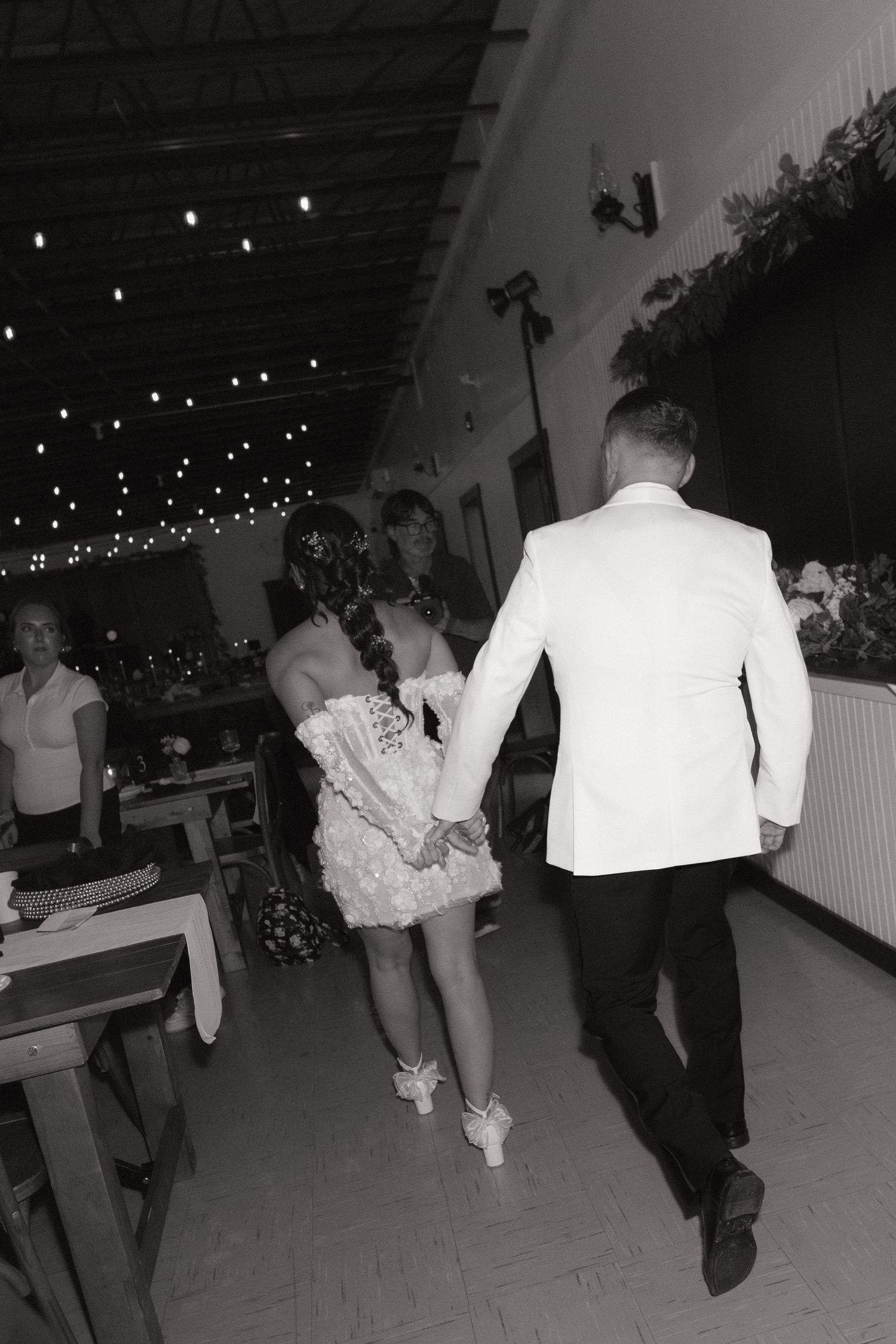 Black and white photos show people dancing and celebrating at a party with string lights visible in the background.
