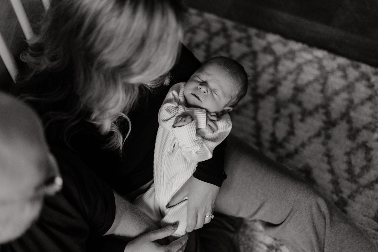 Artistic black and white indoor portrait session with dramatic shadows and lighting.