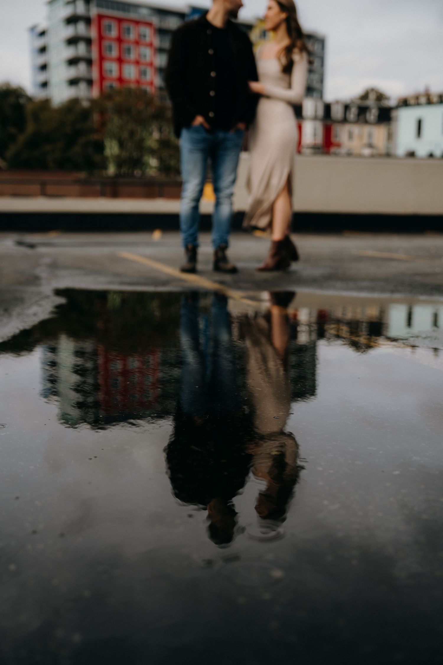 Romantic couple portrait with soft focus and water reflection on an urban rooftop.