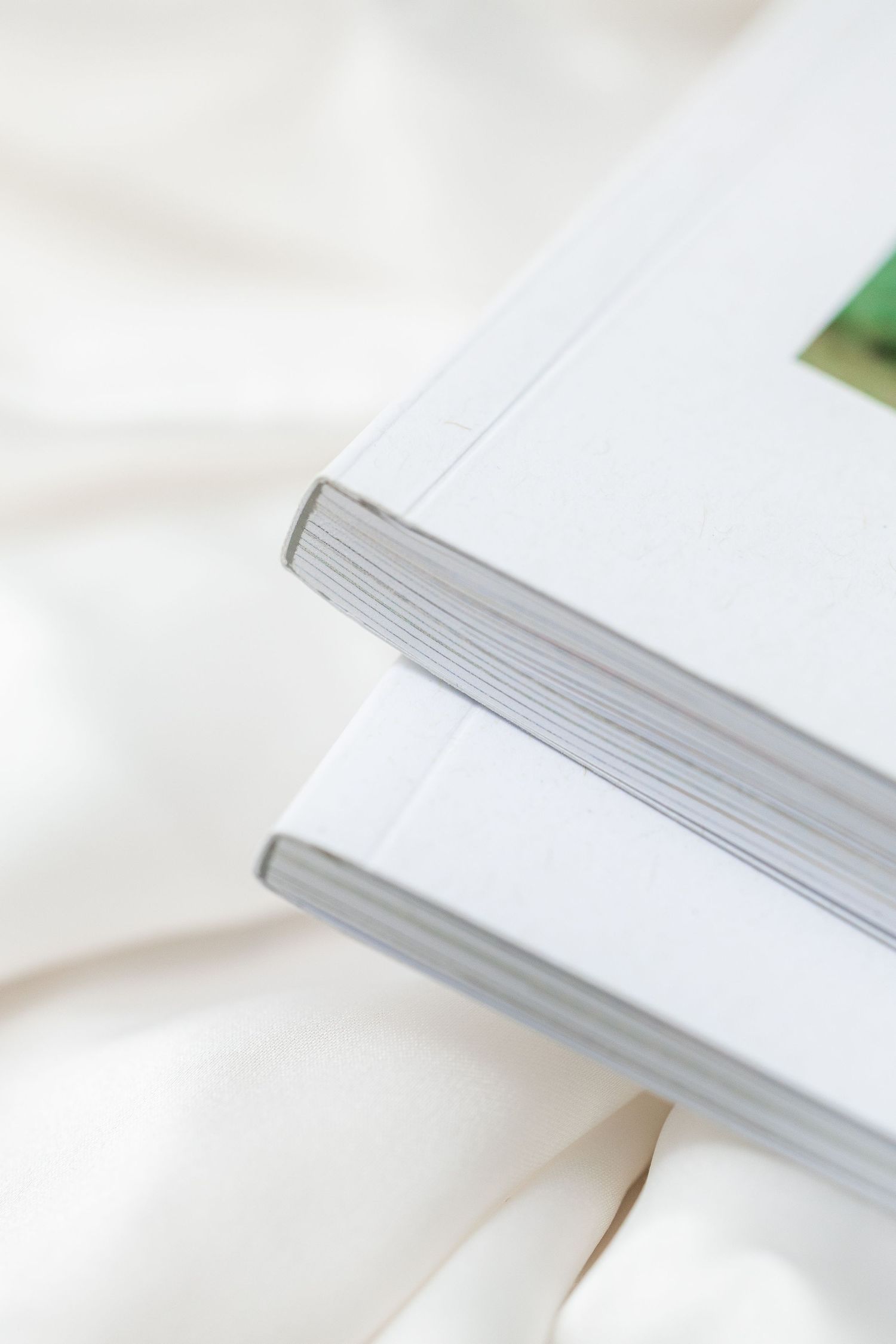 Close-up view of white pages in an open book with blurred edges creating a minimalist composition.