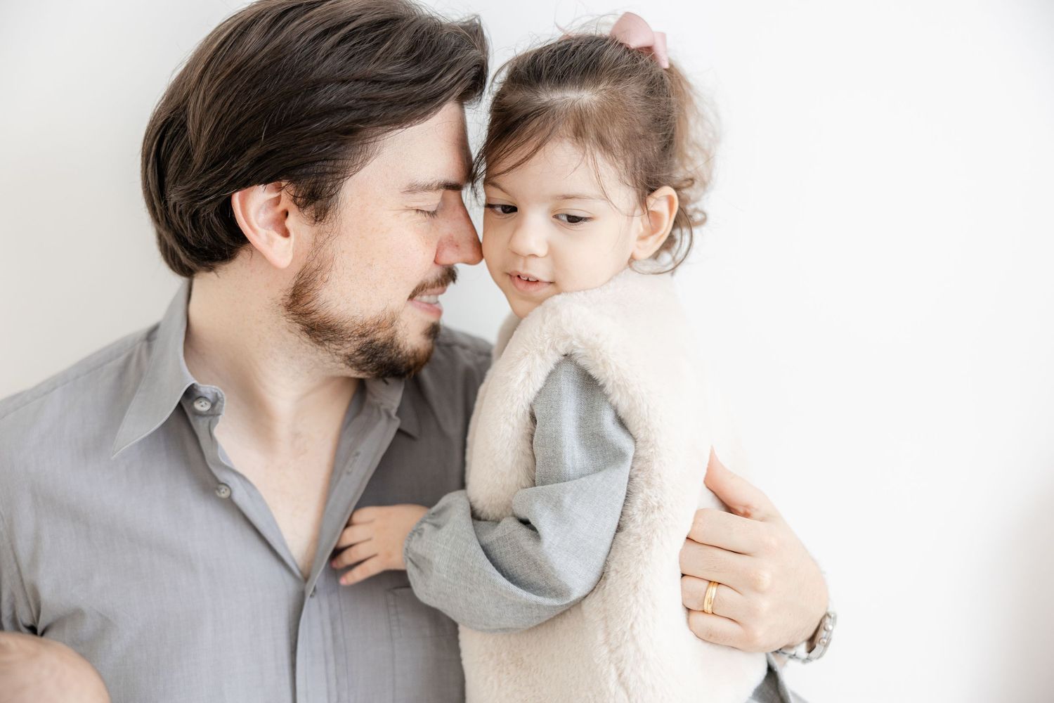 A tender moment between parent and child in soft muted tones showing closeness and affection.