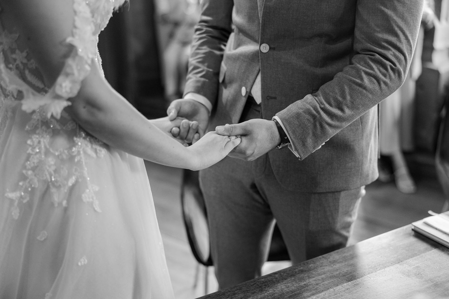 Black and white wedding photo sequence showing couple exchanging rings during intimate ceremony - Hochzeitsfotograf Aargau
