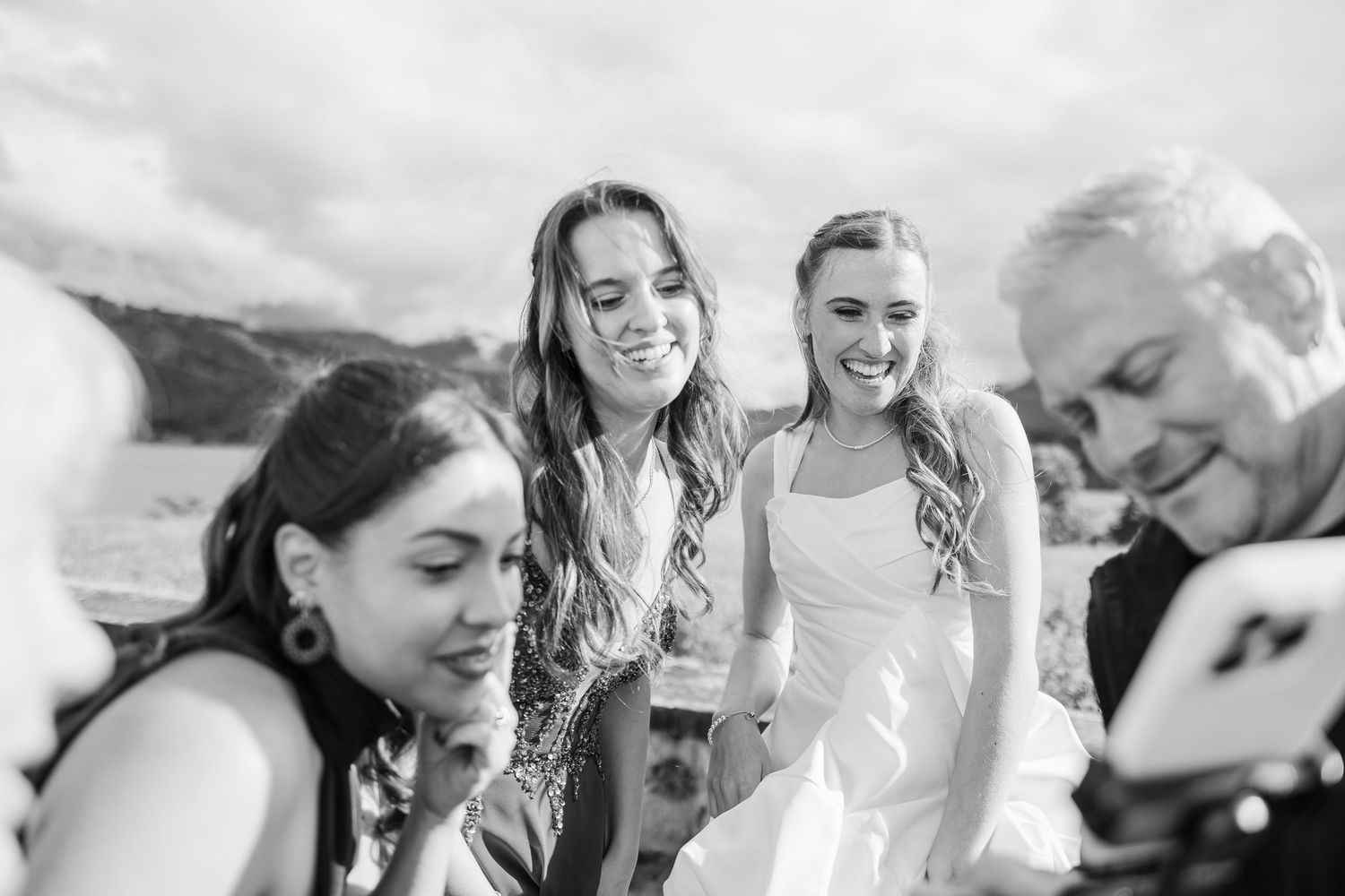 A joyful group celebrates outdoors during a sunny summer gathering.