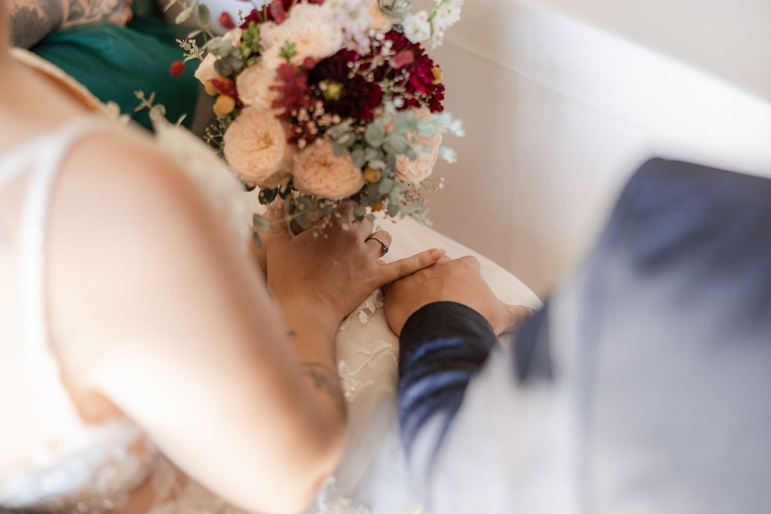A delicate display of pink roses and baby's breath flowers arranged in romantic wedding photography compositions.