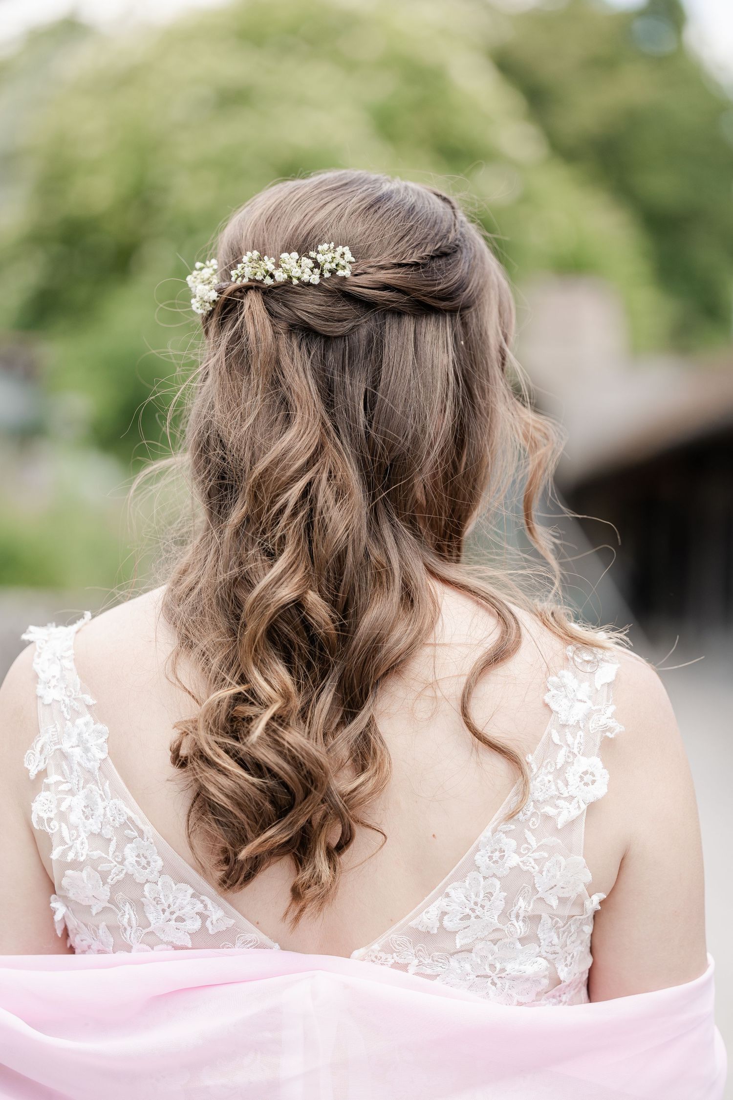 Elegant bridal hairstyle with soft curls and delicate lace details shown from multiple angles in a garden setting.