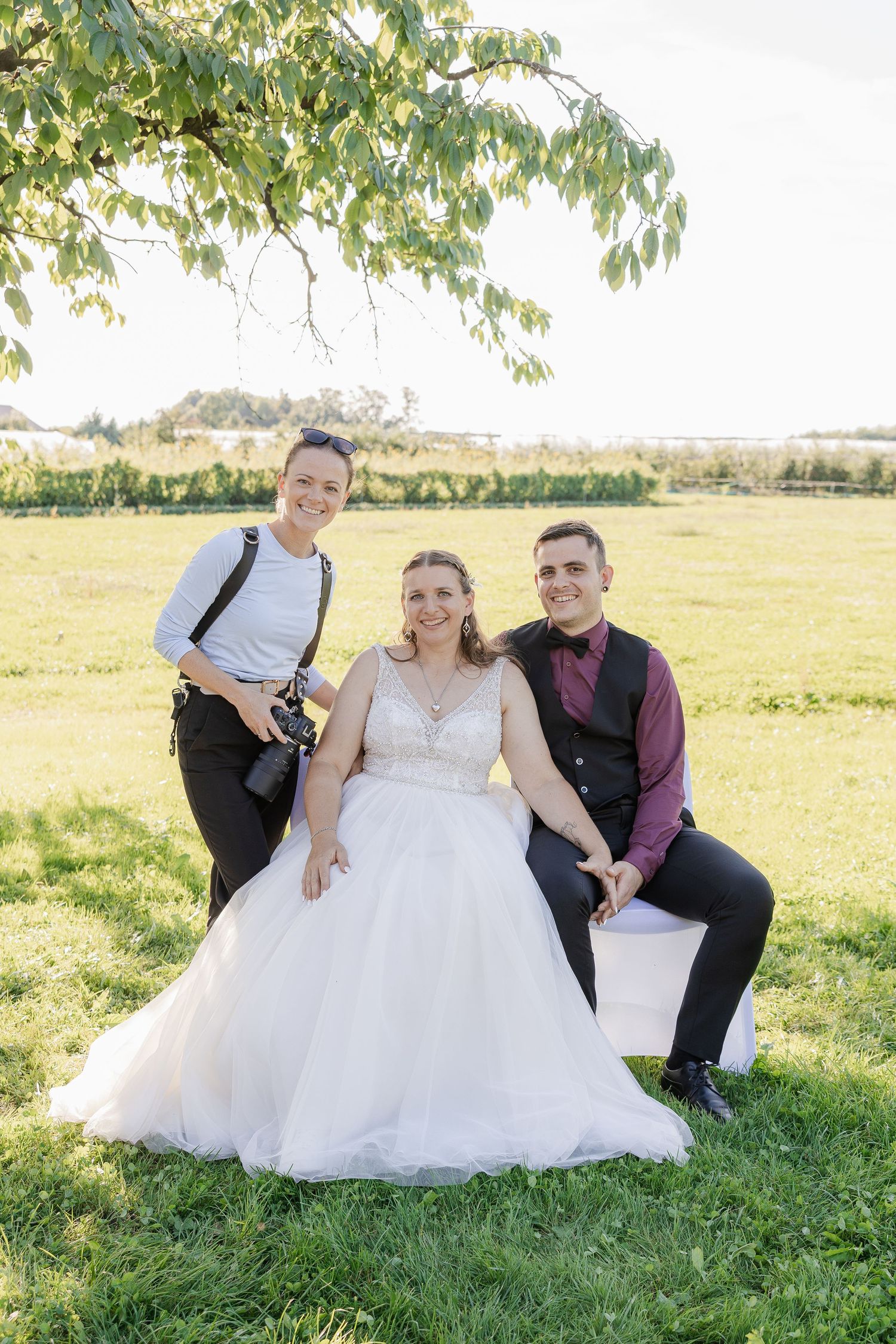 A couple poses together on grassy hillside during their outdoor wedding photo session - Hochzeitsfotograf Luzern